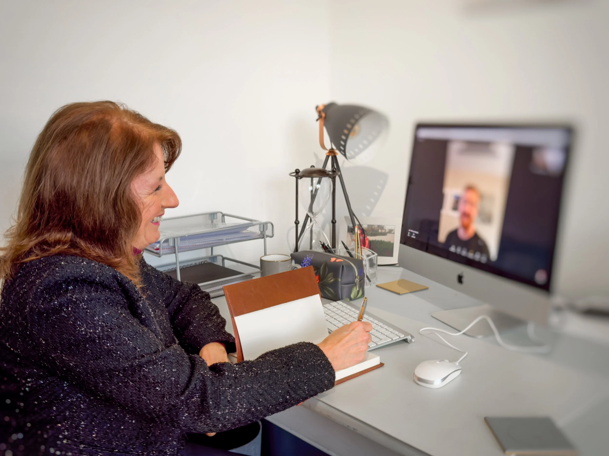 Anne Martin conducting a one-to-one online mentoring session with a senior leader, providing personalised leadership guidance via video call.