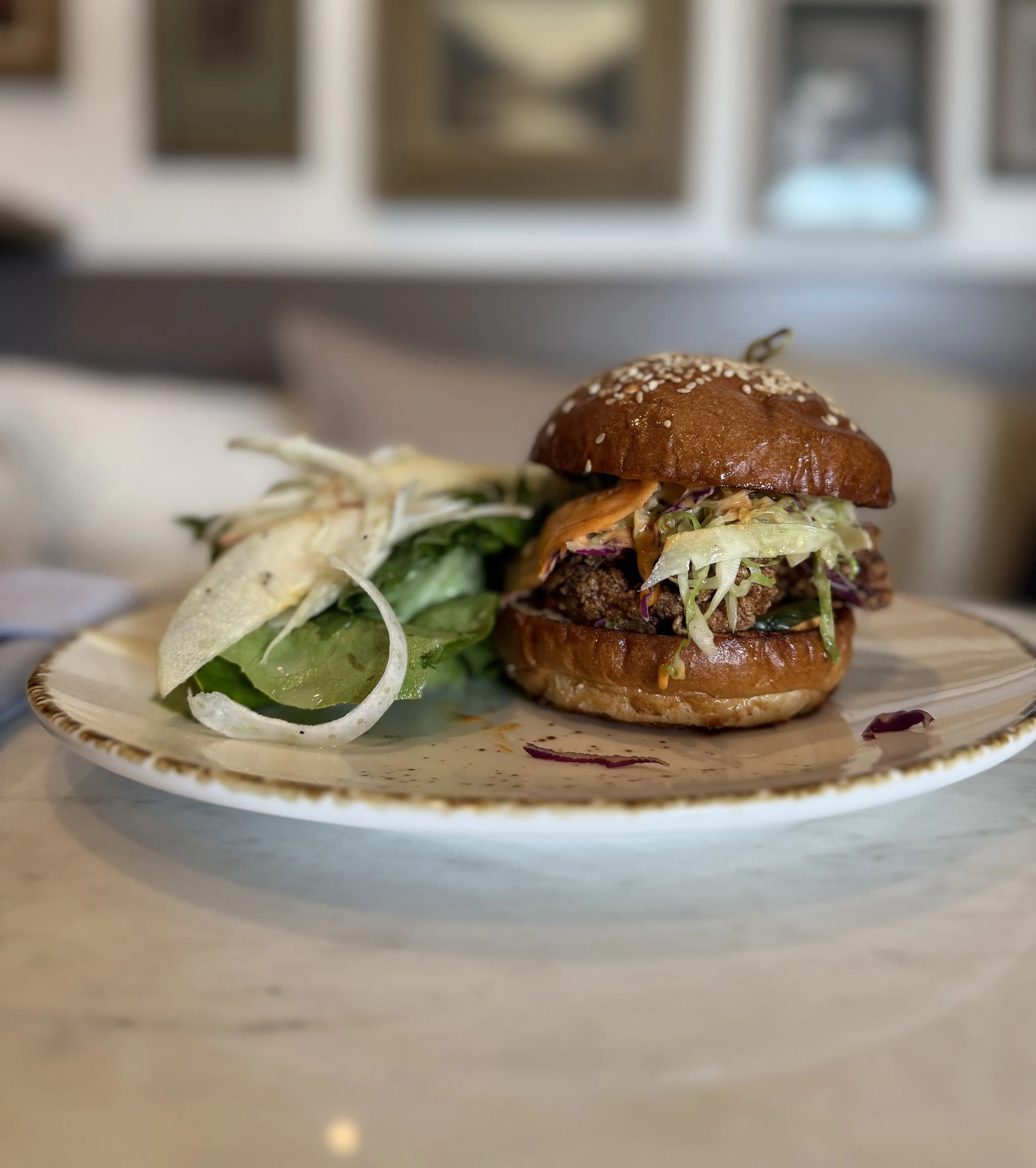 Mary’s Fried Chicken Sandwich
buttermilk brine vinegar, slaw & fresno aioli, dill pickles, baked bar sesame bun & butter lettuce salad-apple salad, poppy seed dressing