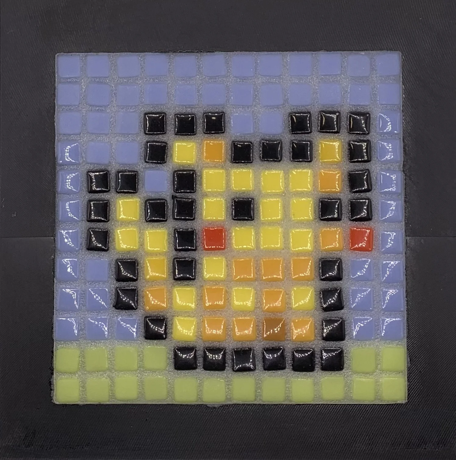 Colorful mosaic tile artwork resembling a pixelated portrait of a famous mouse.