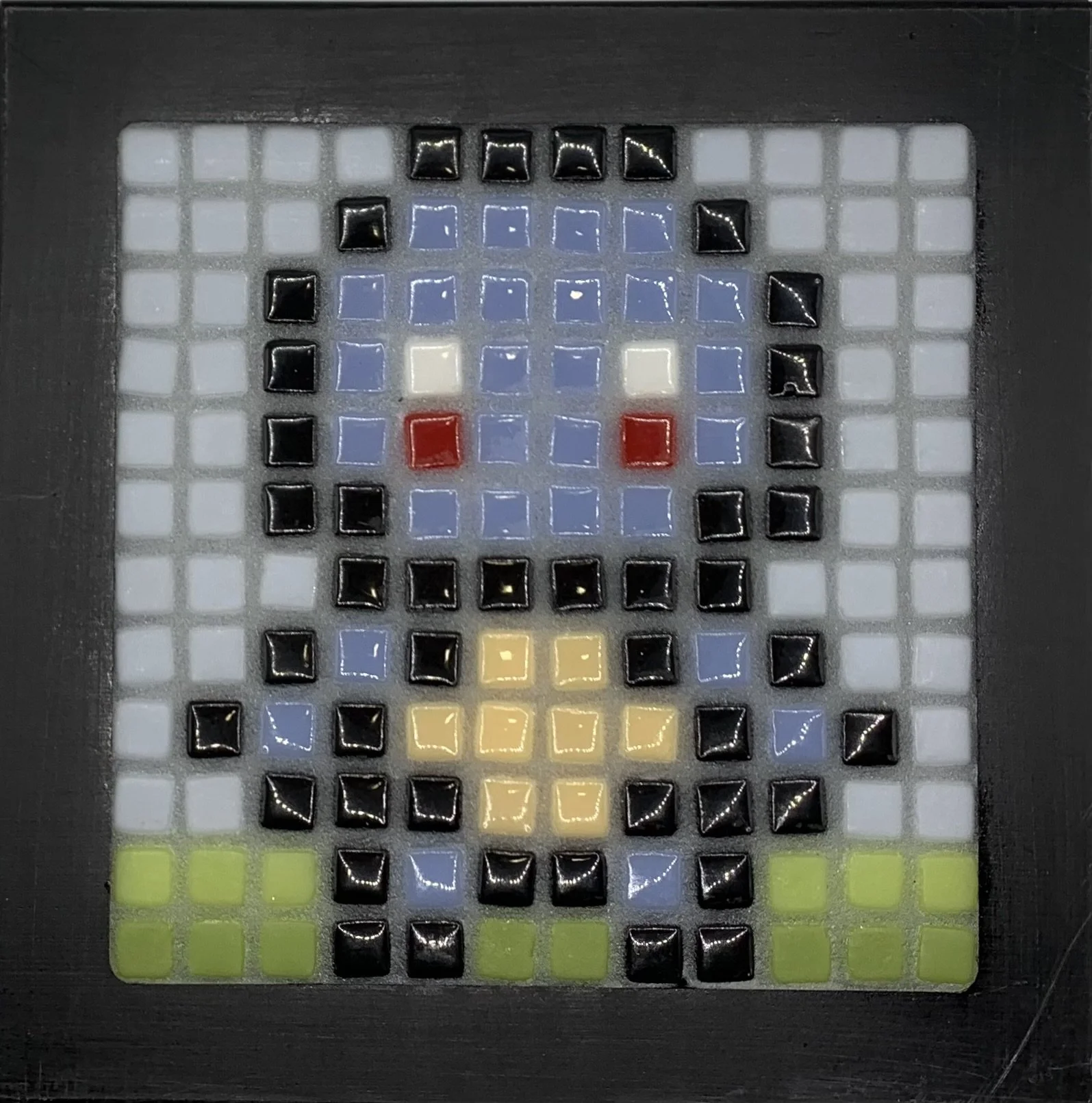 A grid-based mosaic pixel art of a face with blue hair, red cheeks, yellow nose, and green hair, created with small colored tiles in a black frame.