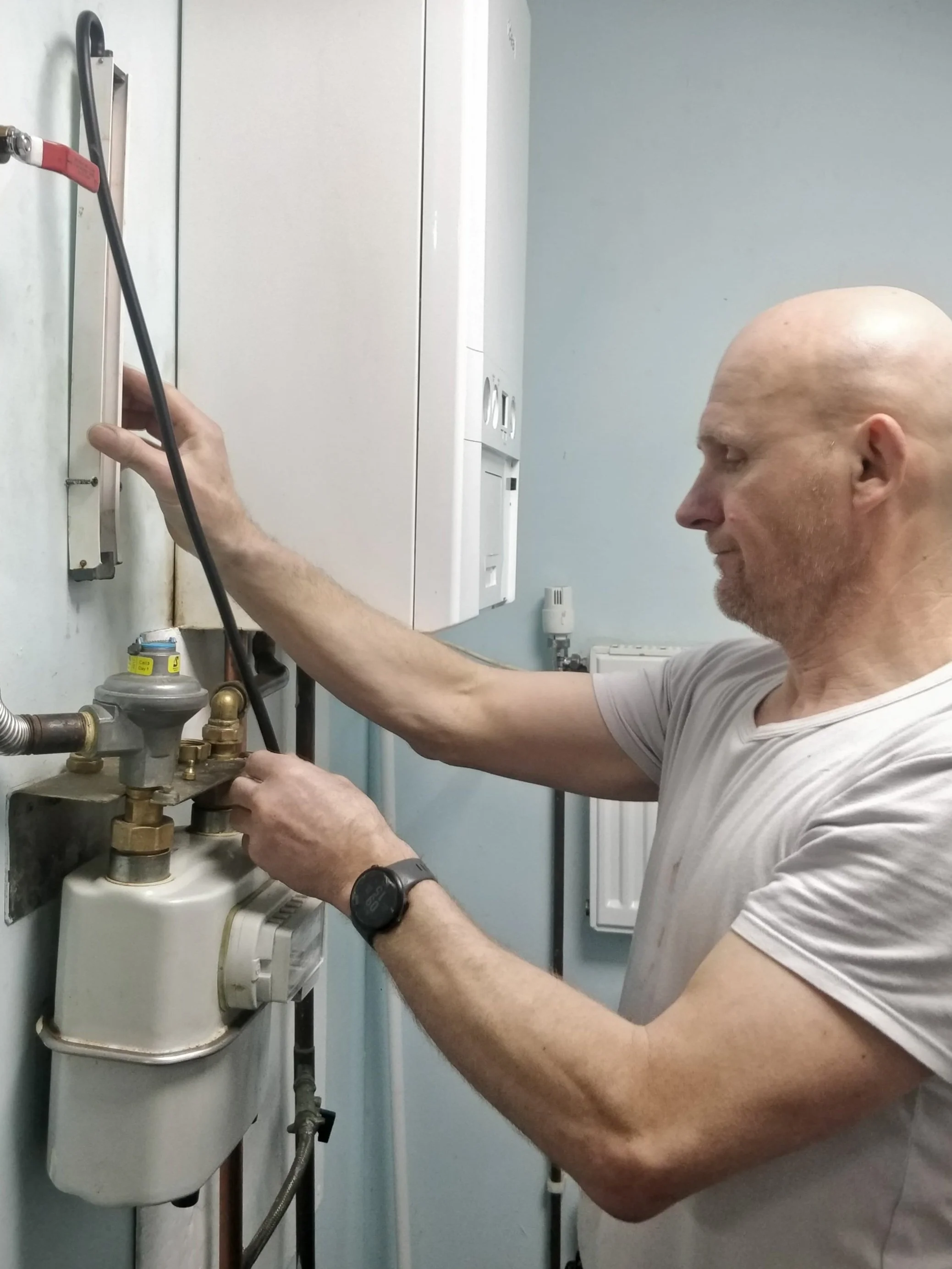 Wal, Gas Safe engineer at WMC Plumbing and Heating, inspecting a domestic boiler