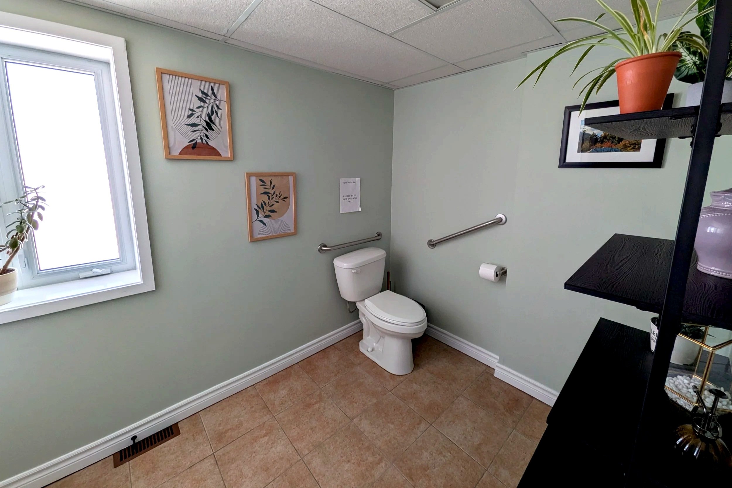 Waiting area washroom at Root Bloom Thrive, a mental health clinic comprised of therapists and a Registered Dietitian in Sudbury, Ontario. The washroom is gender neutral and wheelchair accessible.