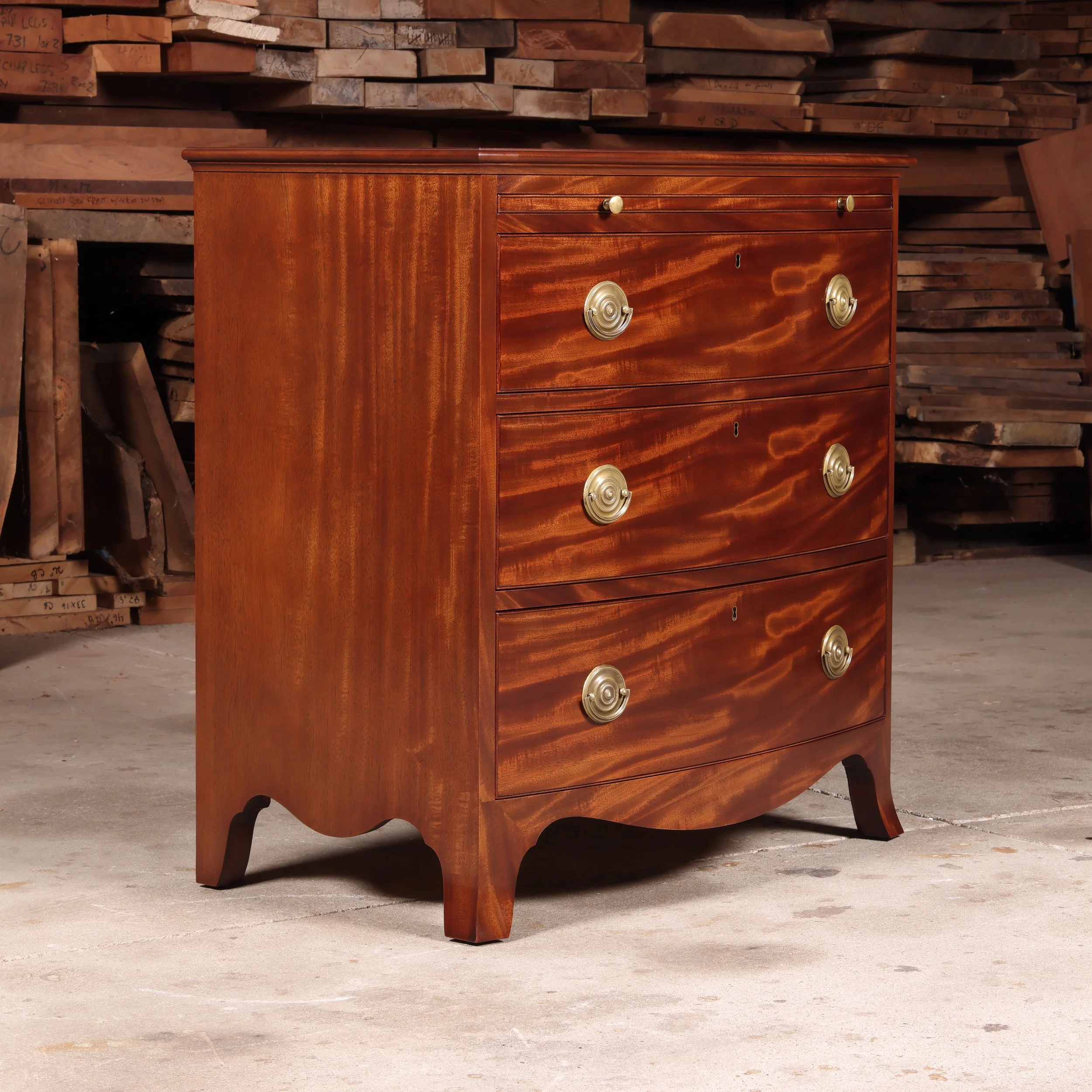 Handmade Bow Front Chest with Writing Surface in figured mahogany.