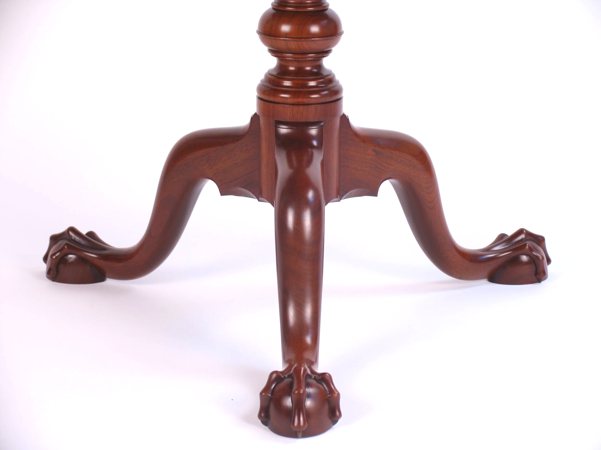 Detail of hand shaped cabriole legs ending with hand carved ball and claw feet.