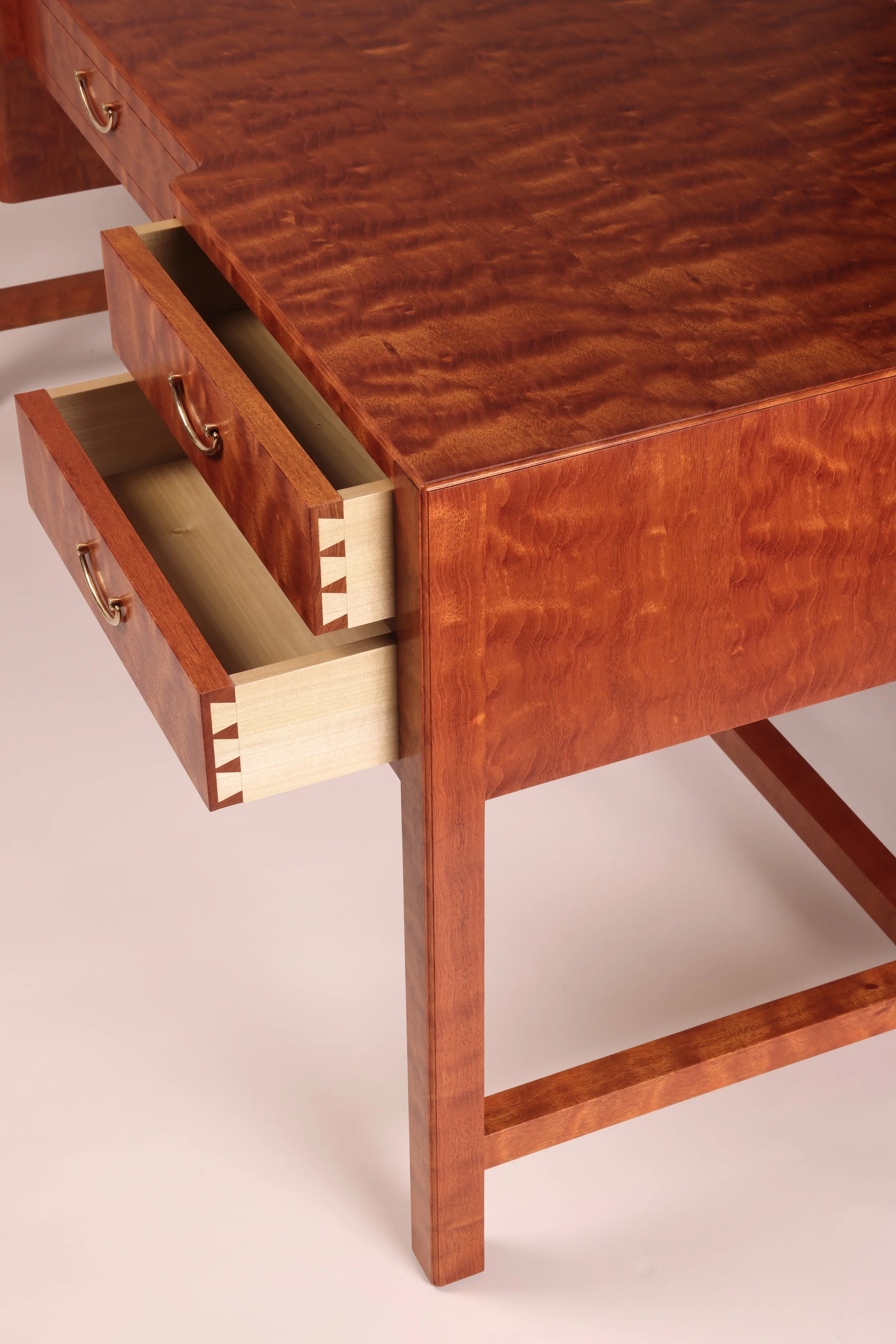 Custom made mahogany executive desk close up highlighting hand cut dovetail drawers and hand rubbed lacquer finish.