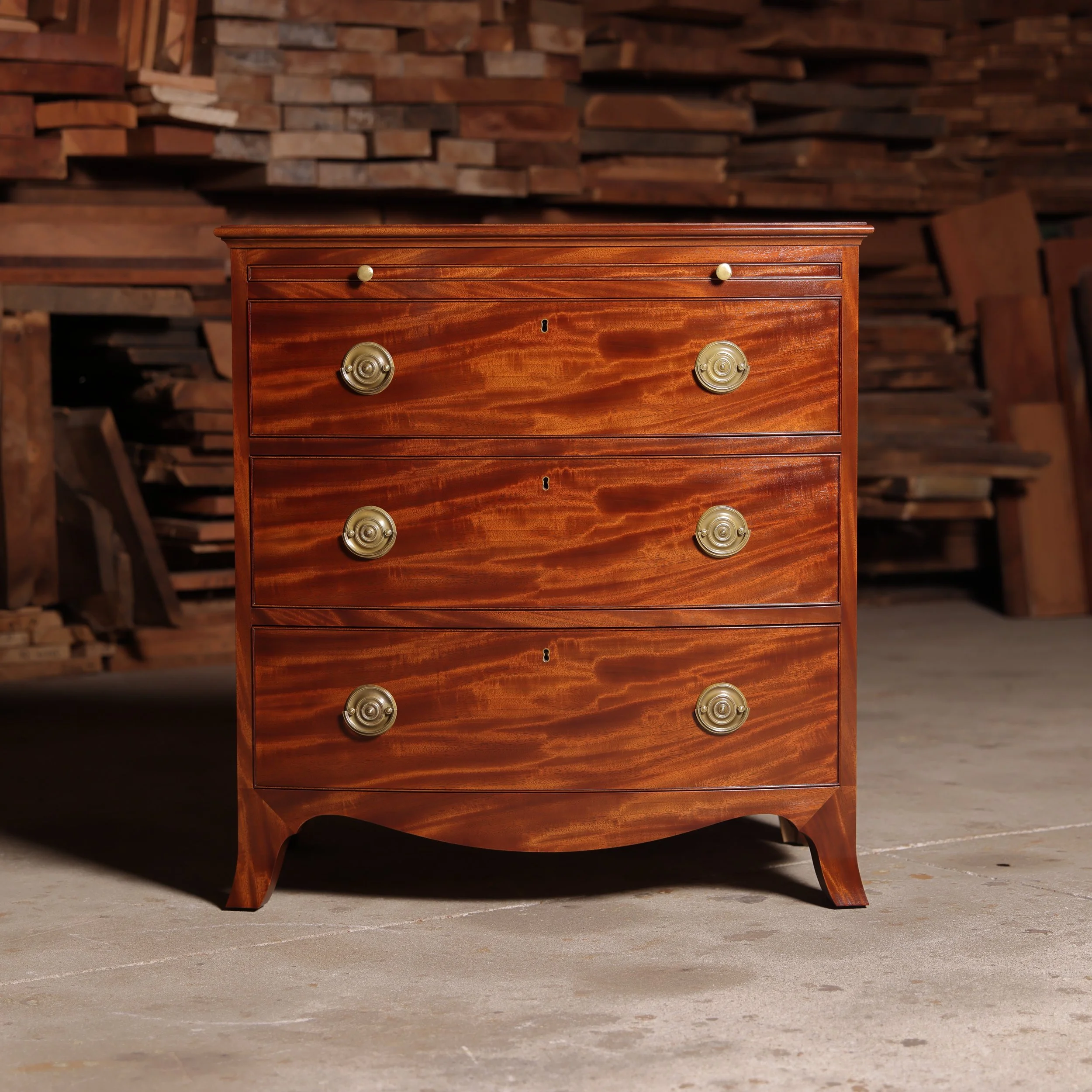Handcrafted Bow Front Chest with Writing Surface in figured mahogany.
