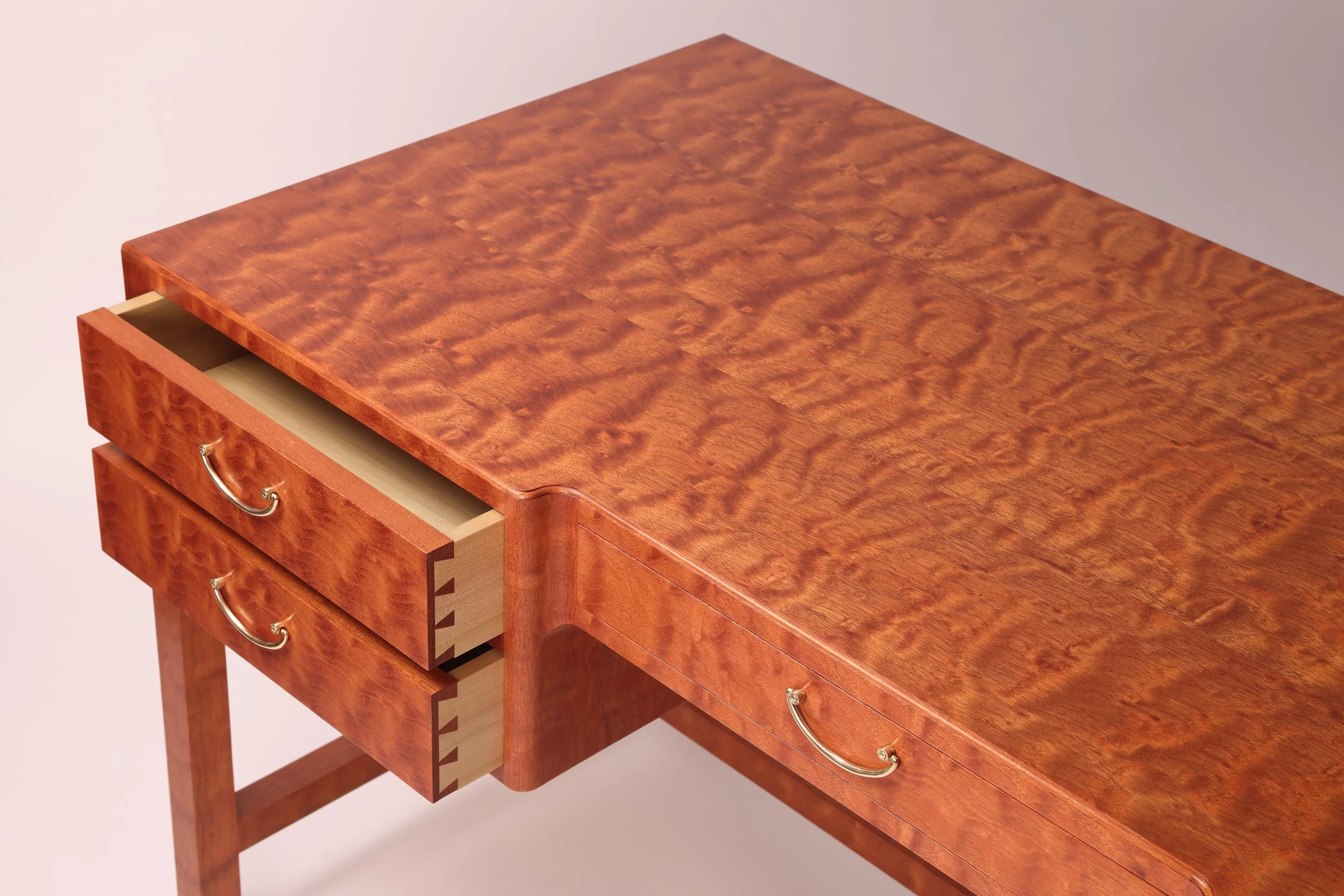 Bespoke mahogany executive desk close up highlighting hand cut dovetail drawers and hand rubbed lacquer finish.