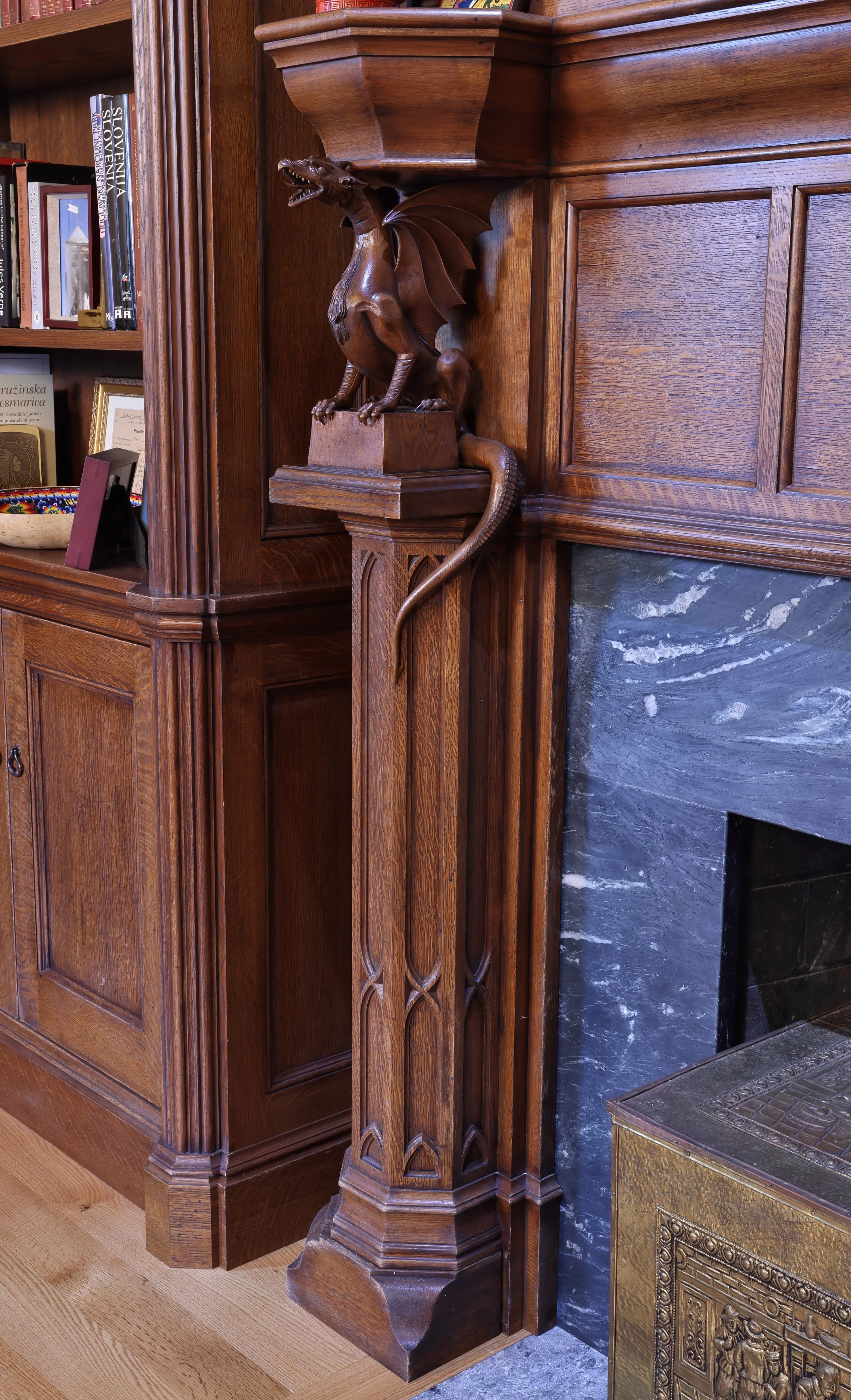 Close up of hand carved oak dragon, Gothic style fireplace decoration, detailed architectural wood carving.
