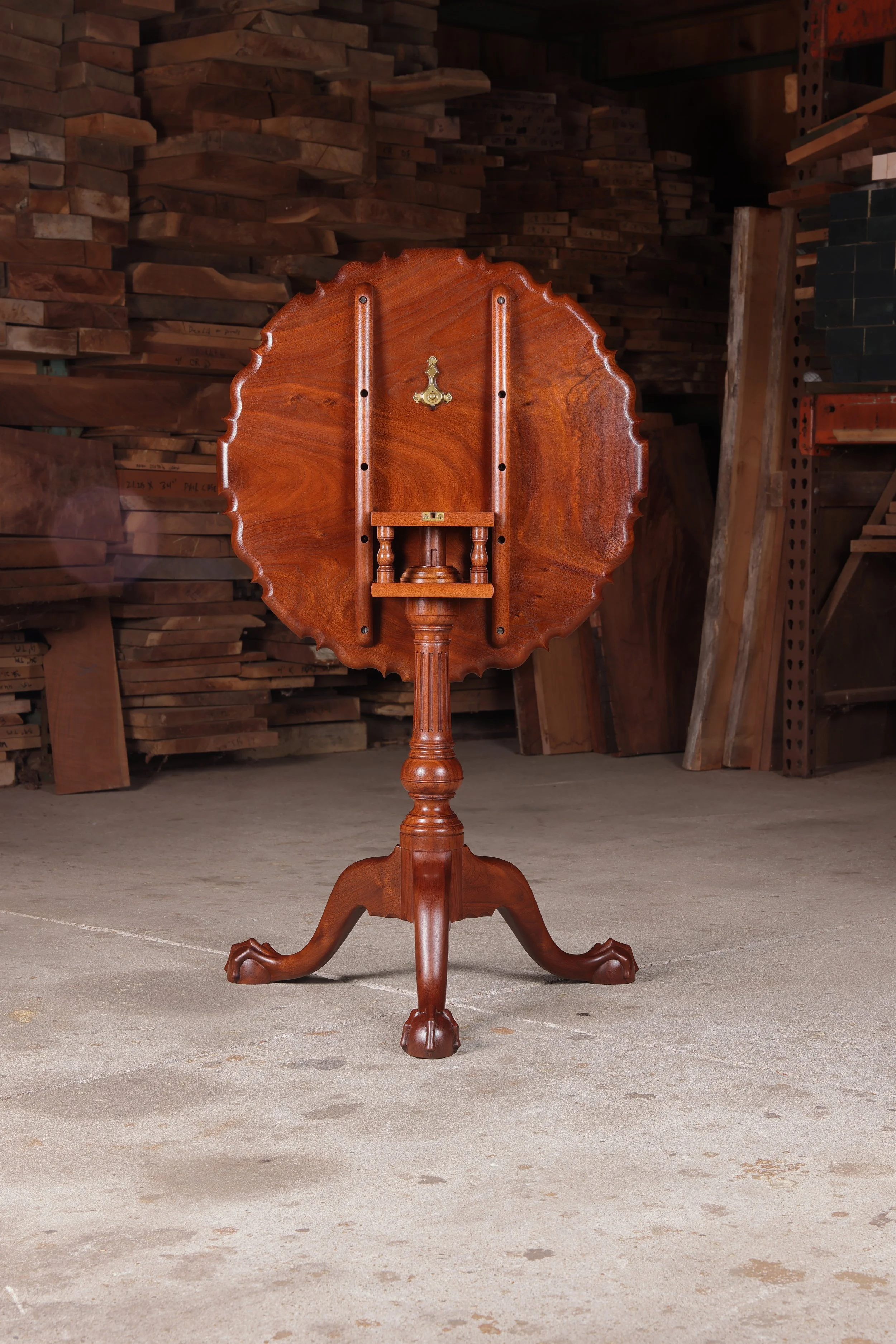 A view of the traditional walnut birdcage mechanism that allows the hand-carved top to tilt and rotate.