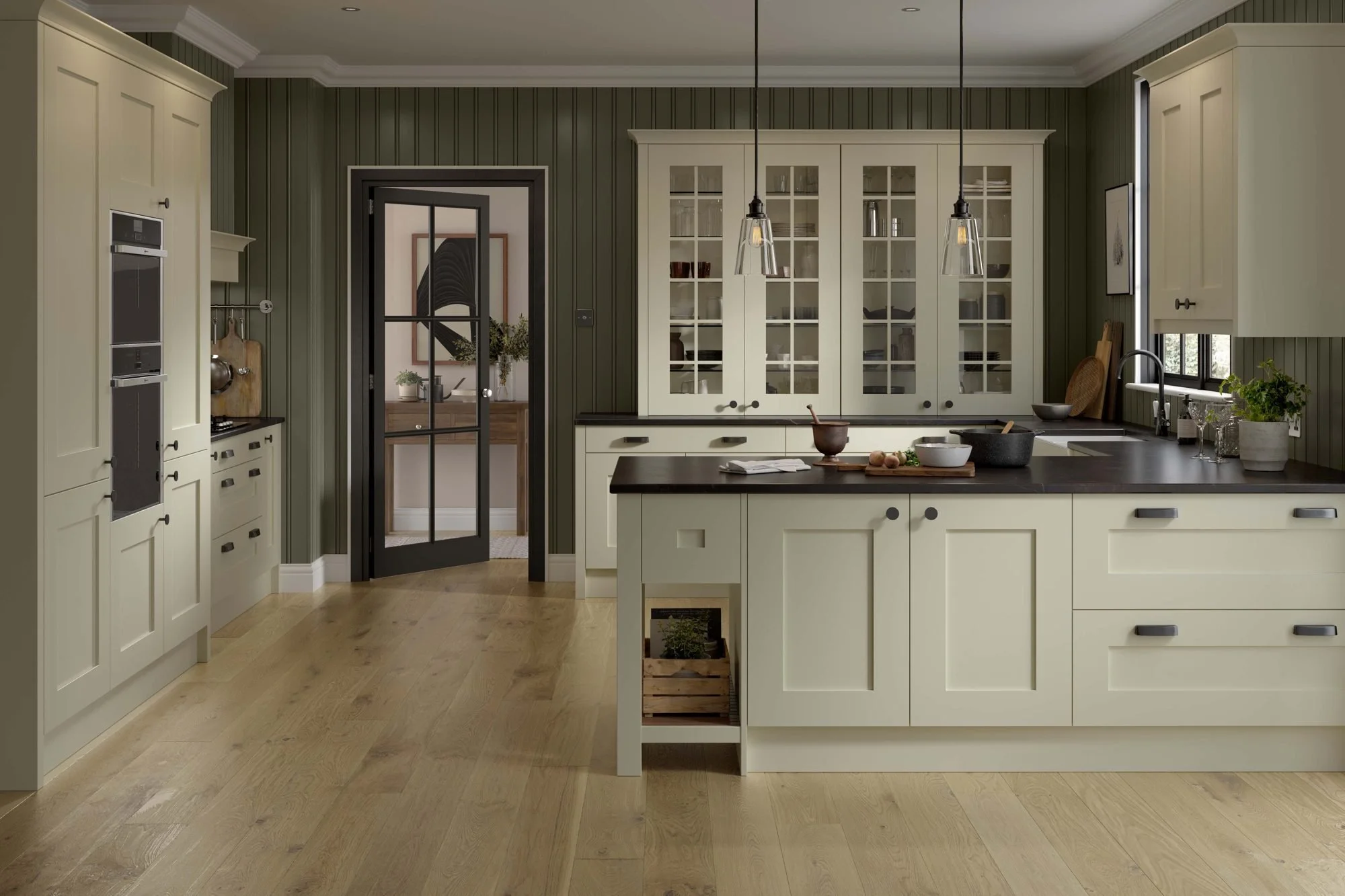 Cream shaker kitchen with tall ovens on one wall, a glazed dresser at the back and units wrapping round three sides