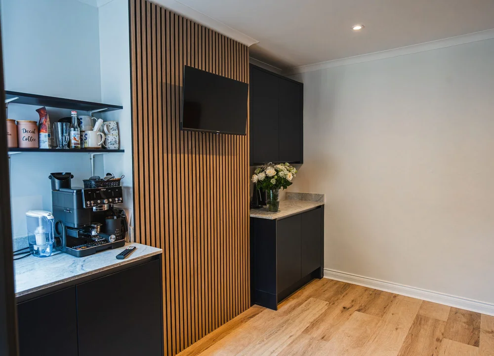 Oak slats and indigo units seen side on, with open shelving, in a Bognor Regis kitchen