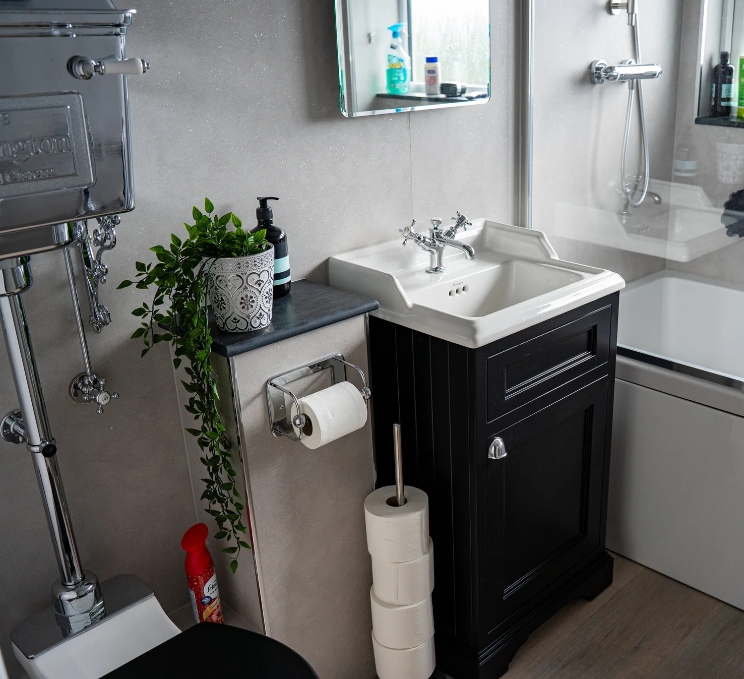 Dark vanity unit with a white basin and crosshead taps in a Lancing bathroom