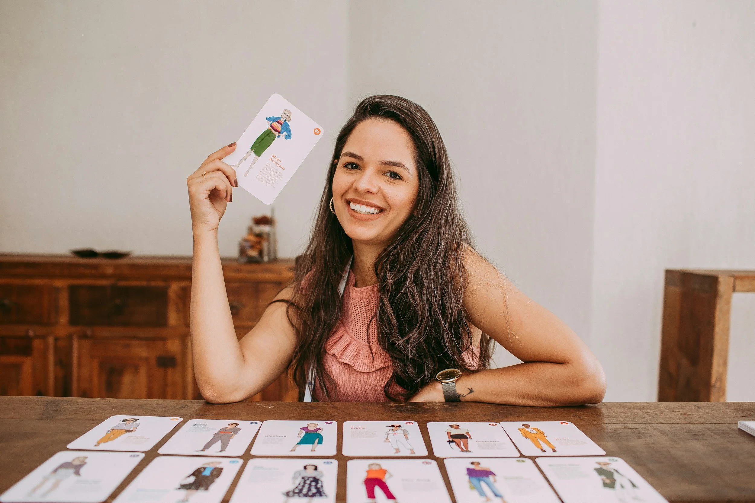 bipoc woman entrepreneur smiling and holding card