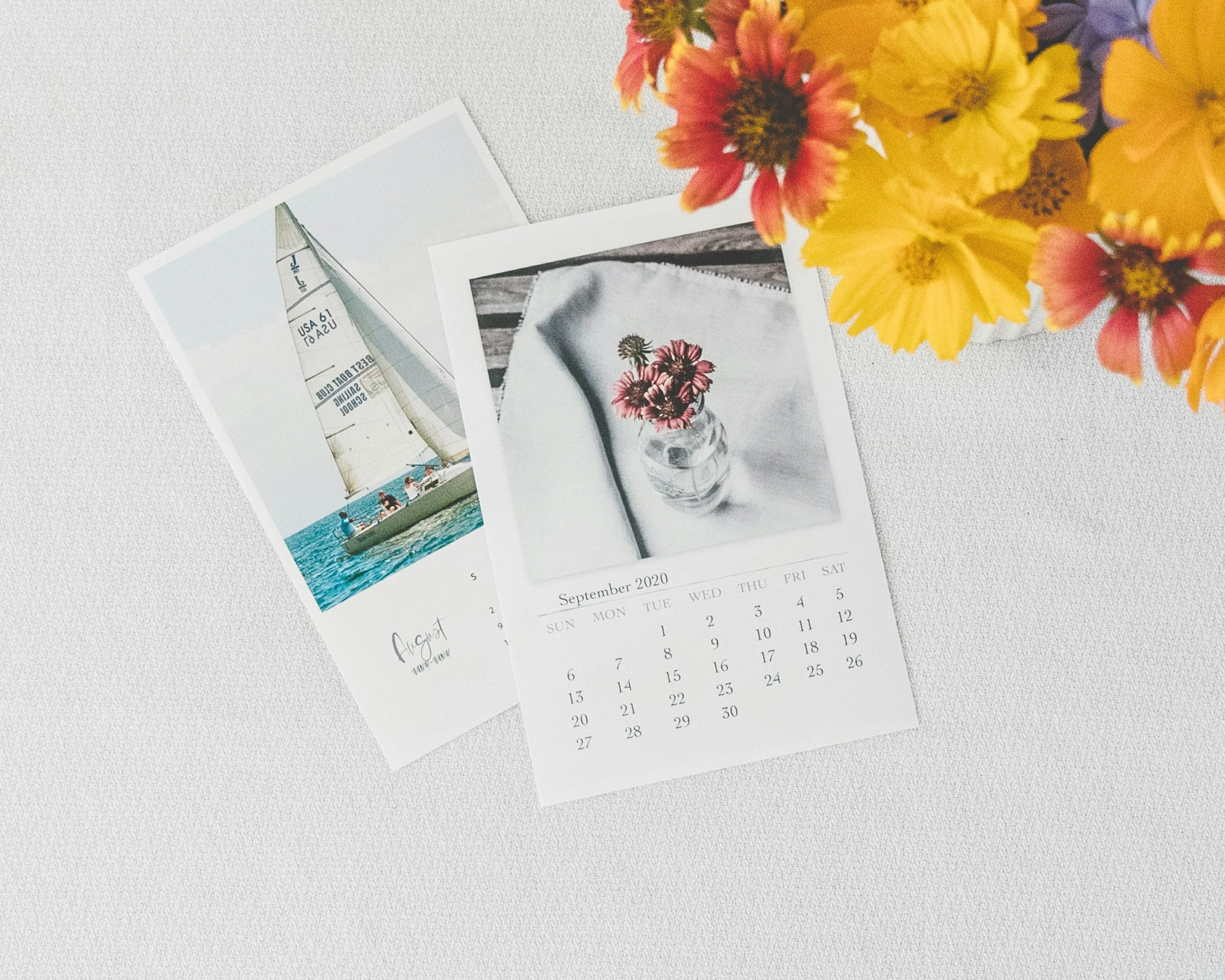 calendar pages with flower & sailboat art