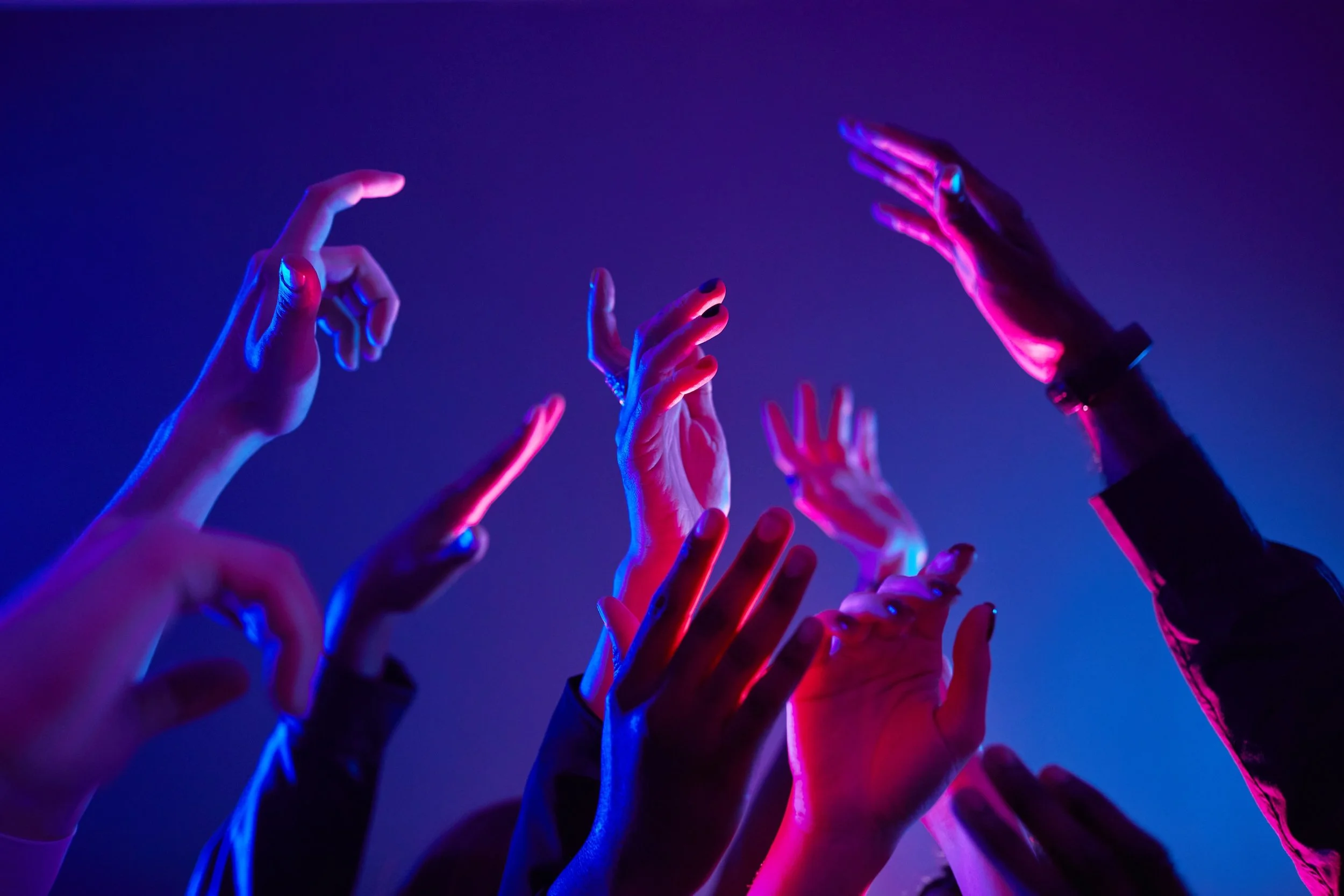 Close-Up_People_Hands_Dancing_In_Neon_Lights_original_3330626.jpg