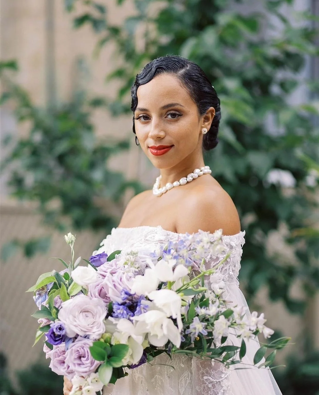 Kiana Madeira on her wedding day at Casa Loma with makeup by Alba Feinaj holding a bouquet of flowers red lipstick old hollywood glam toronto bridal mua bride 2026 2027 destination wedding makeup international mua