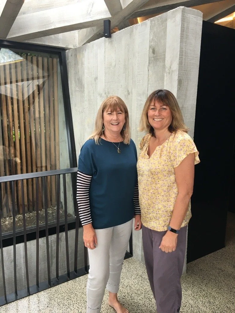 The companies founders standing in front of a concrete wall