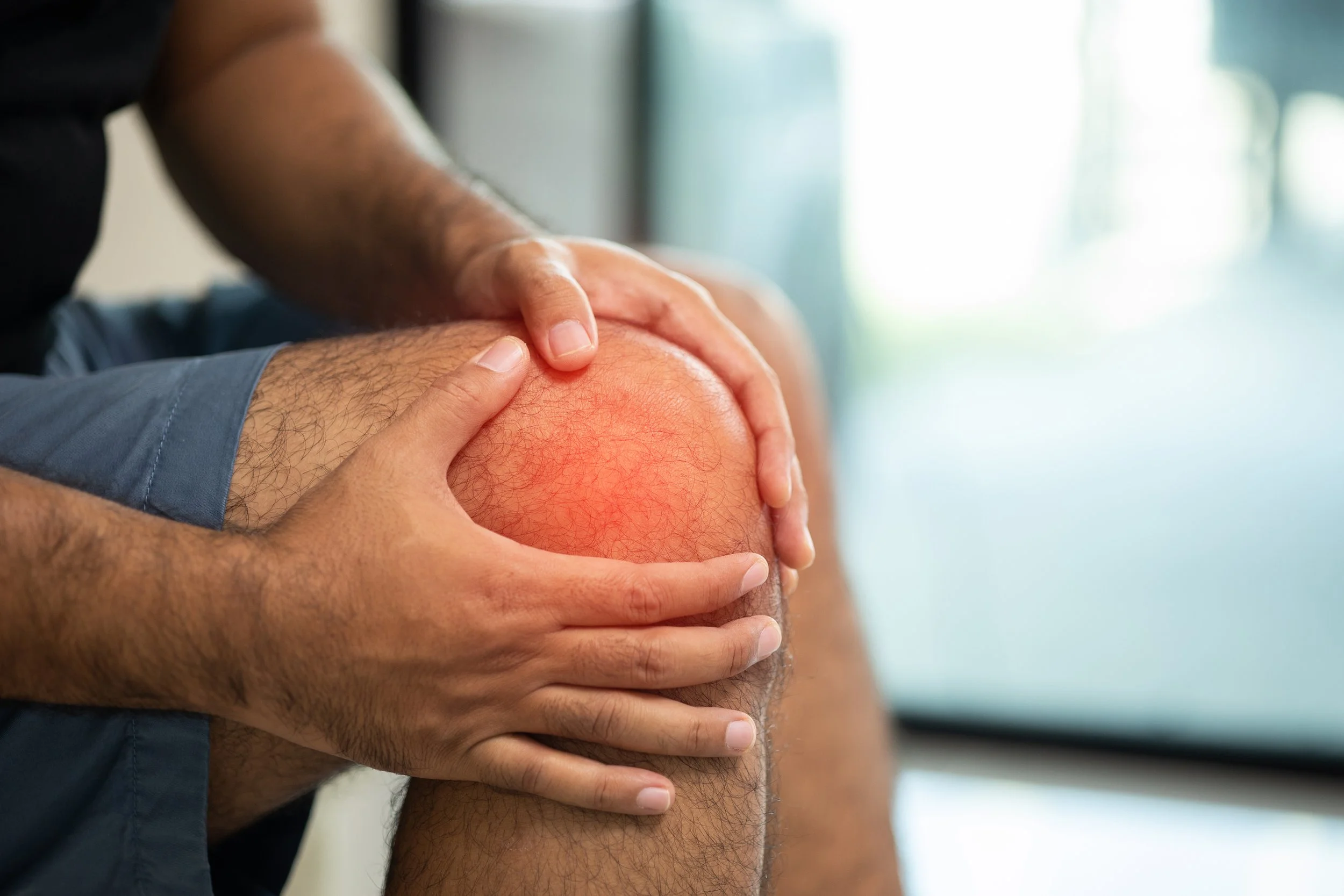 A man holding his hand on his knees He had pain in his knee and could not walk due to PCL tears