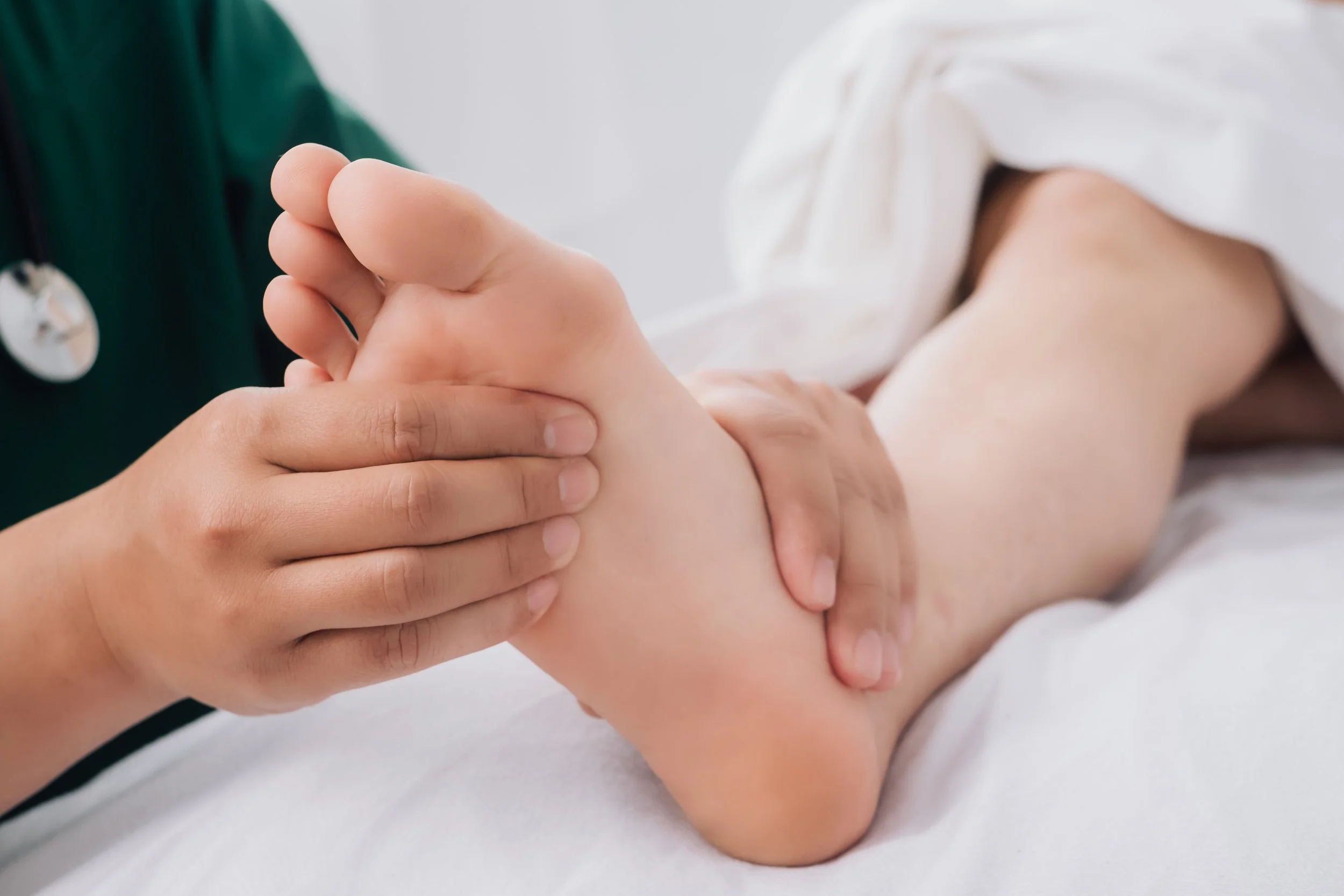 Consultation physiotherapist with the treatment of treating injured ankle pain in modern clinics. Concept of physical rehabilitation