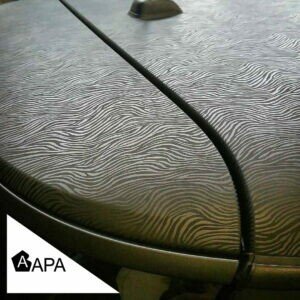 Textured car wrap on vehicle hood with APA logo