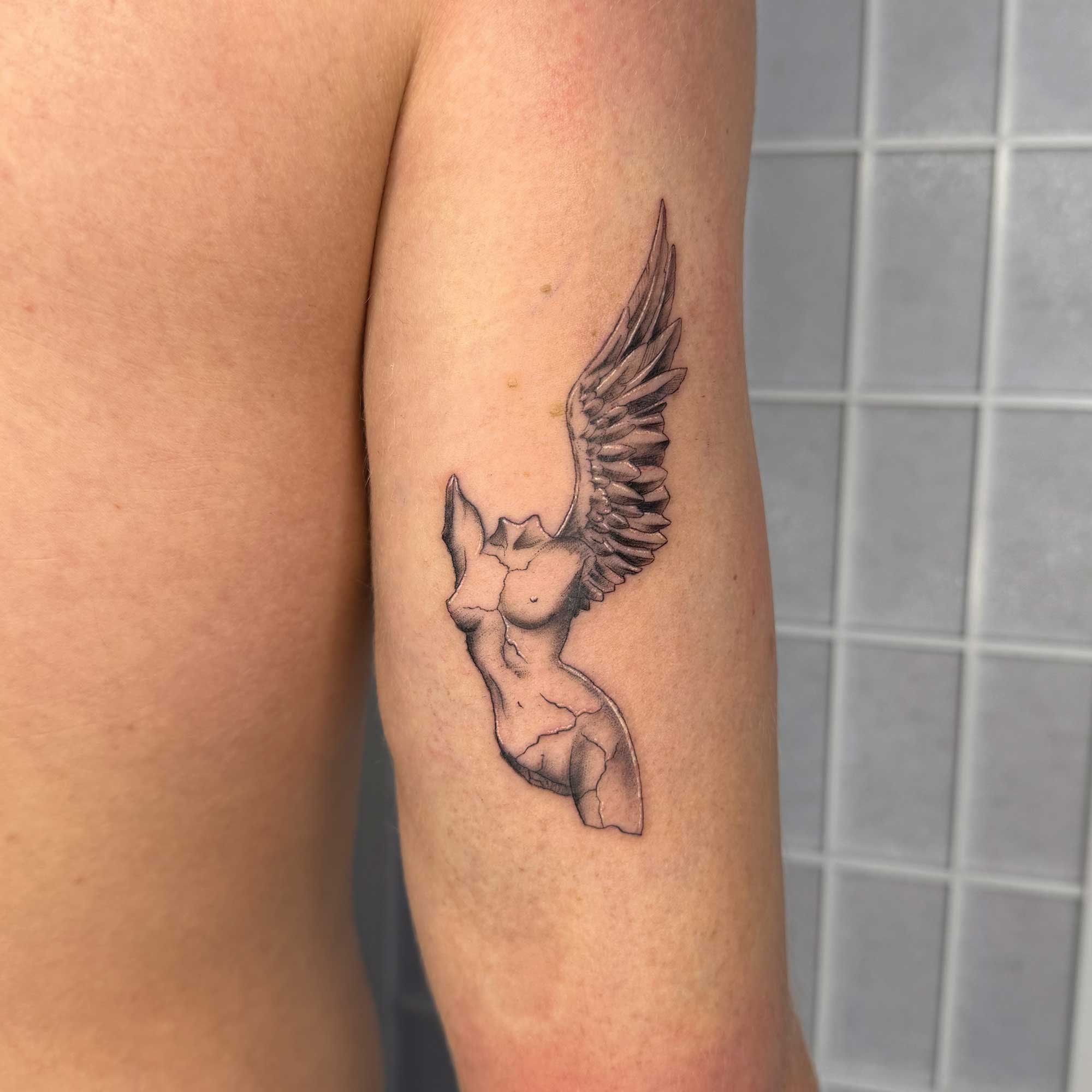 Fine-line statue tattoo by Carl from Bondi fineline tattoo 