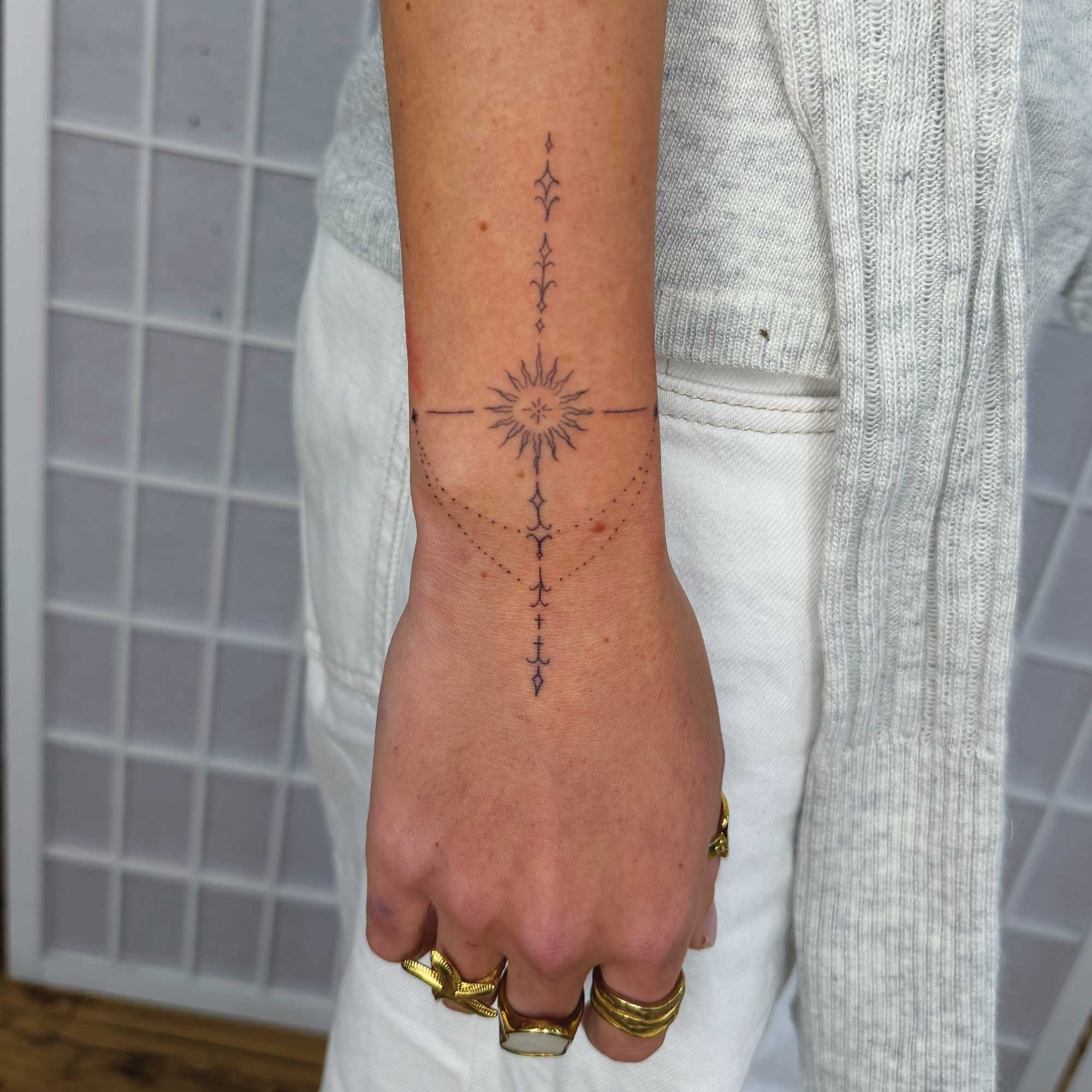 fine-line ornamental cuff tattoo for women