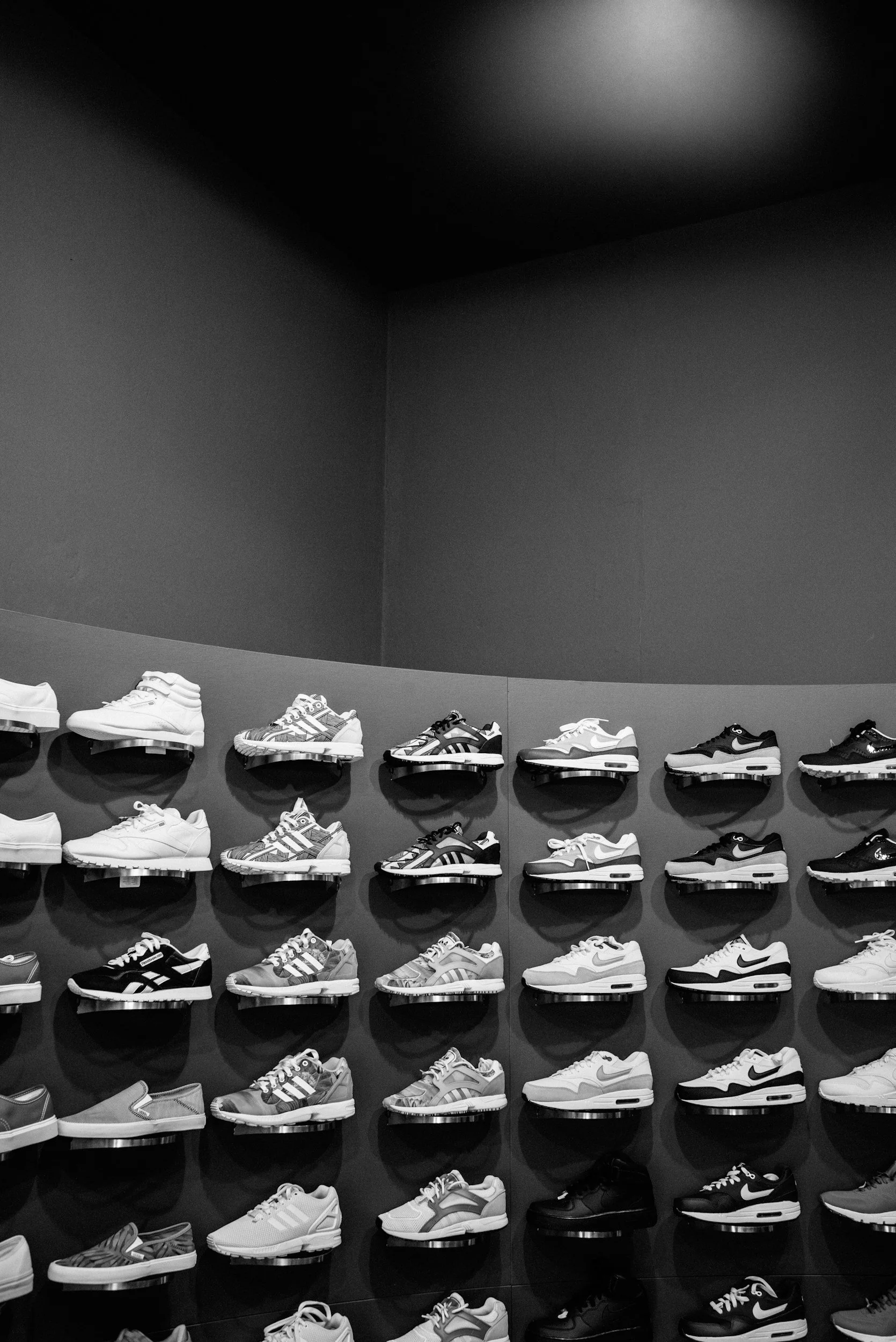 Thumbnail image of a wall display of various shoes representing the Shoes section on the Aglo Designs merchandise page.