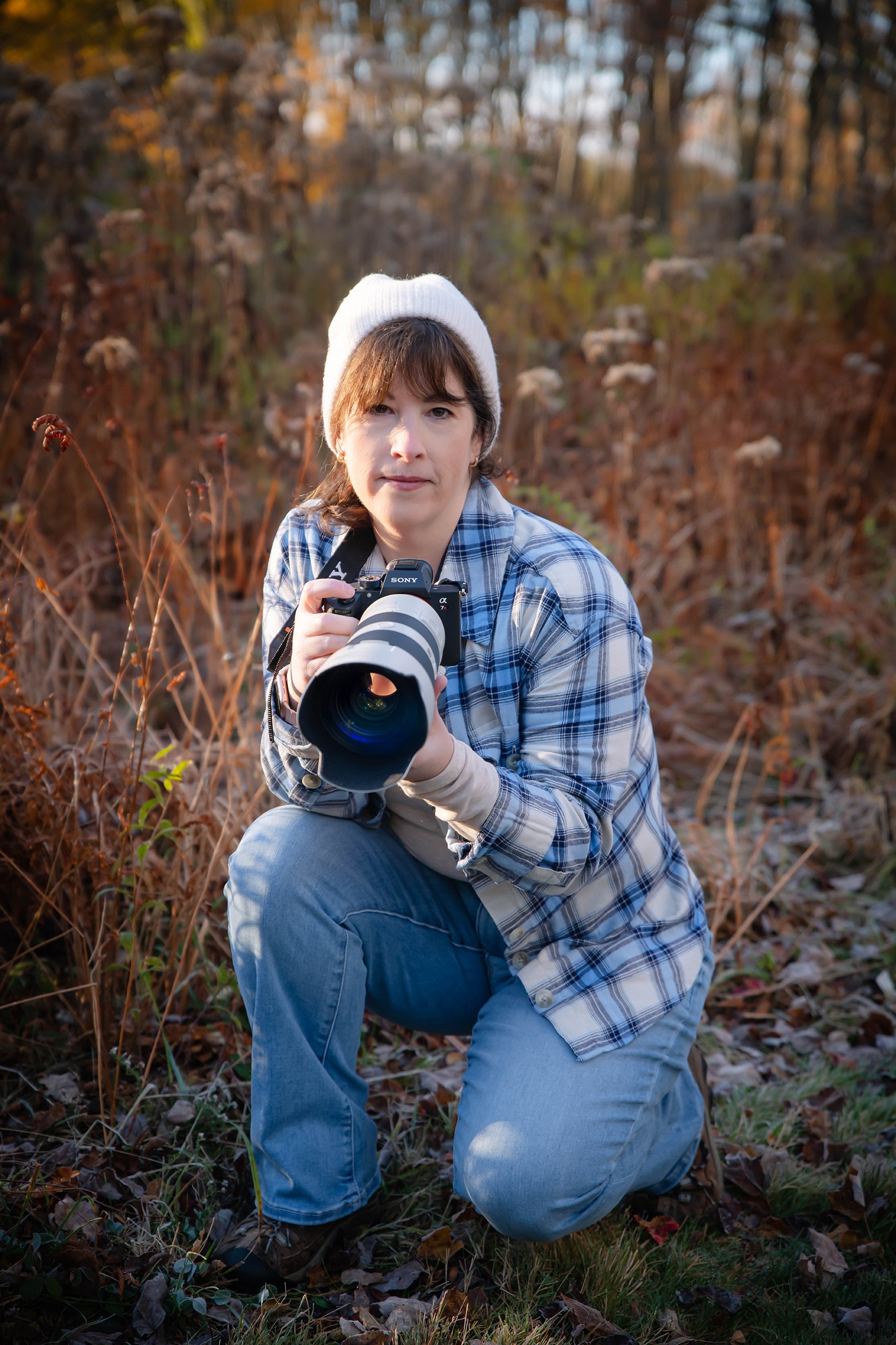 Tricia charles kneeling holding camera