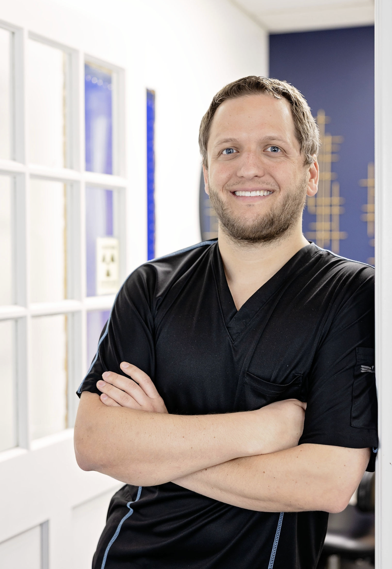Dr. Warren smiling at the door way