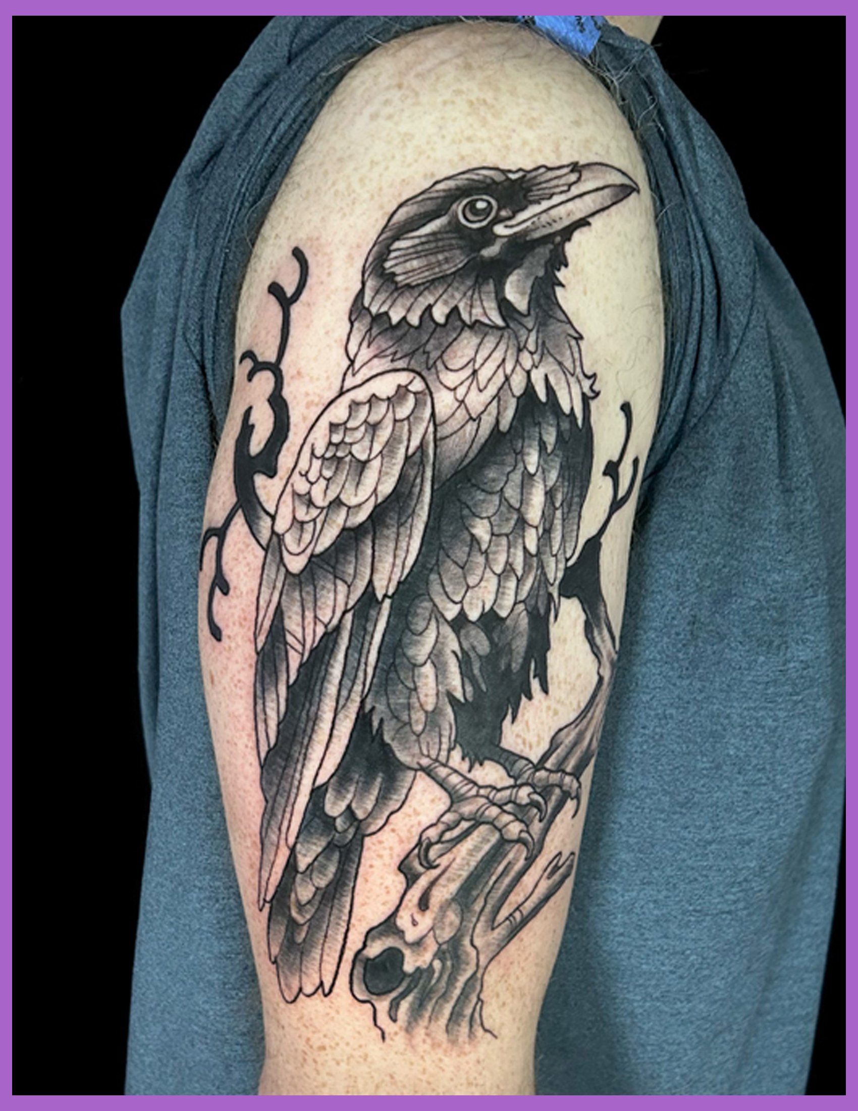 Custom black and grey raven tattoo designed by Canman at Visions Tattoo Gallery in Medway, Massachusetts featuring a detailed realistic raven perched on a weathered branch with textured feathers and nature-inspired composition on the upper arm.