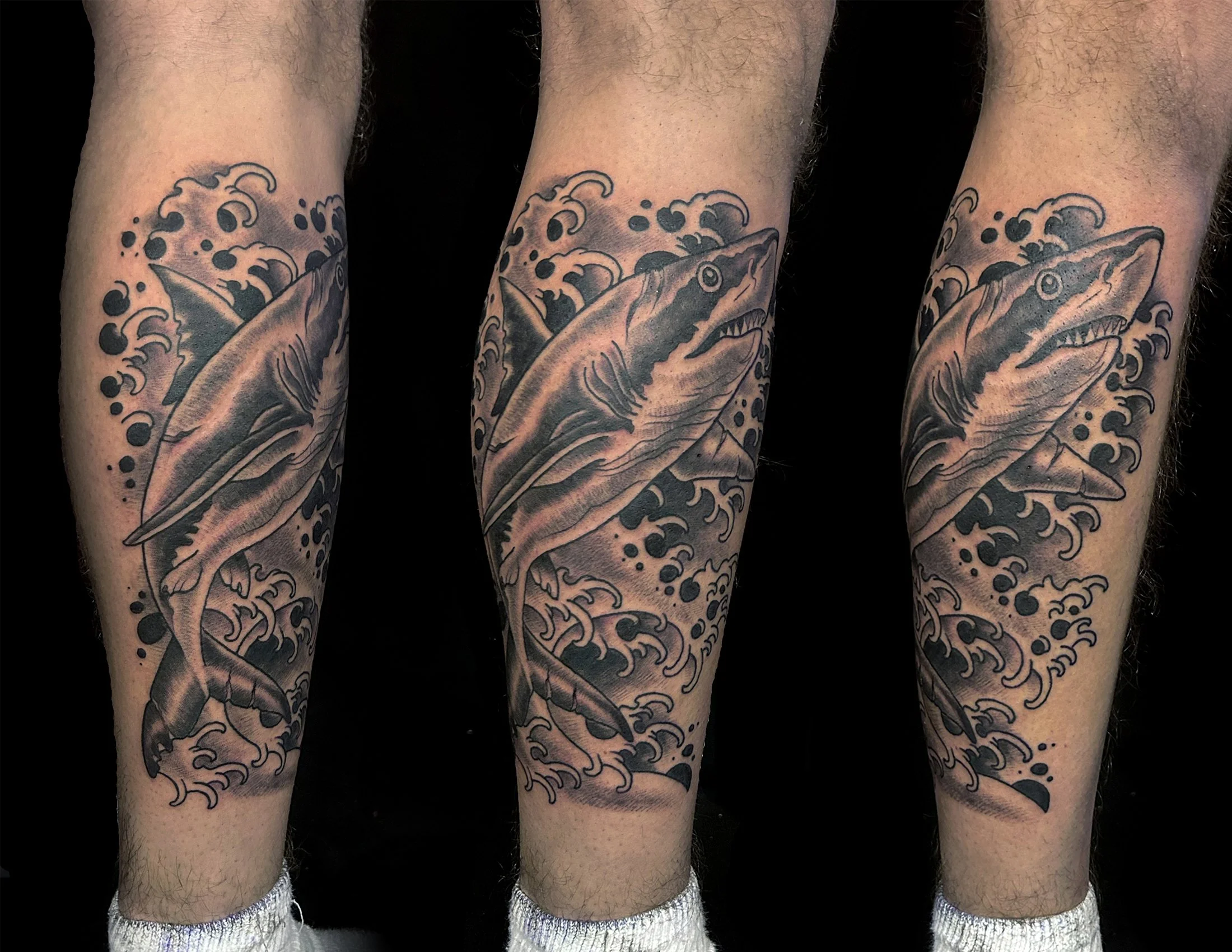 Check out Canman’s bold black-and-grey shark tattoo — a dramatic, realistic marine design that combines fluid movement and strong contrast. Perfect for fans of ocean-themed ink and large-scale custom tattoos.