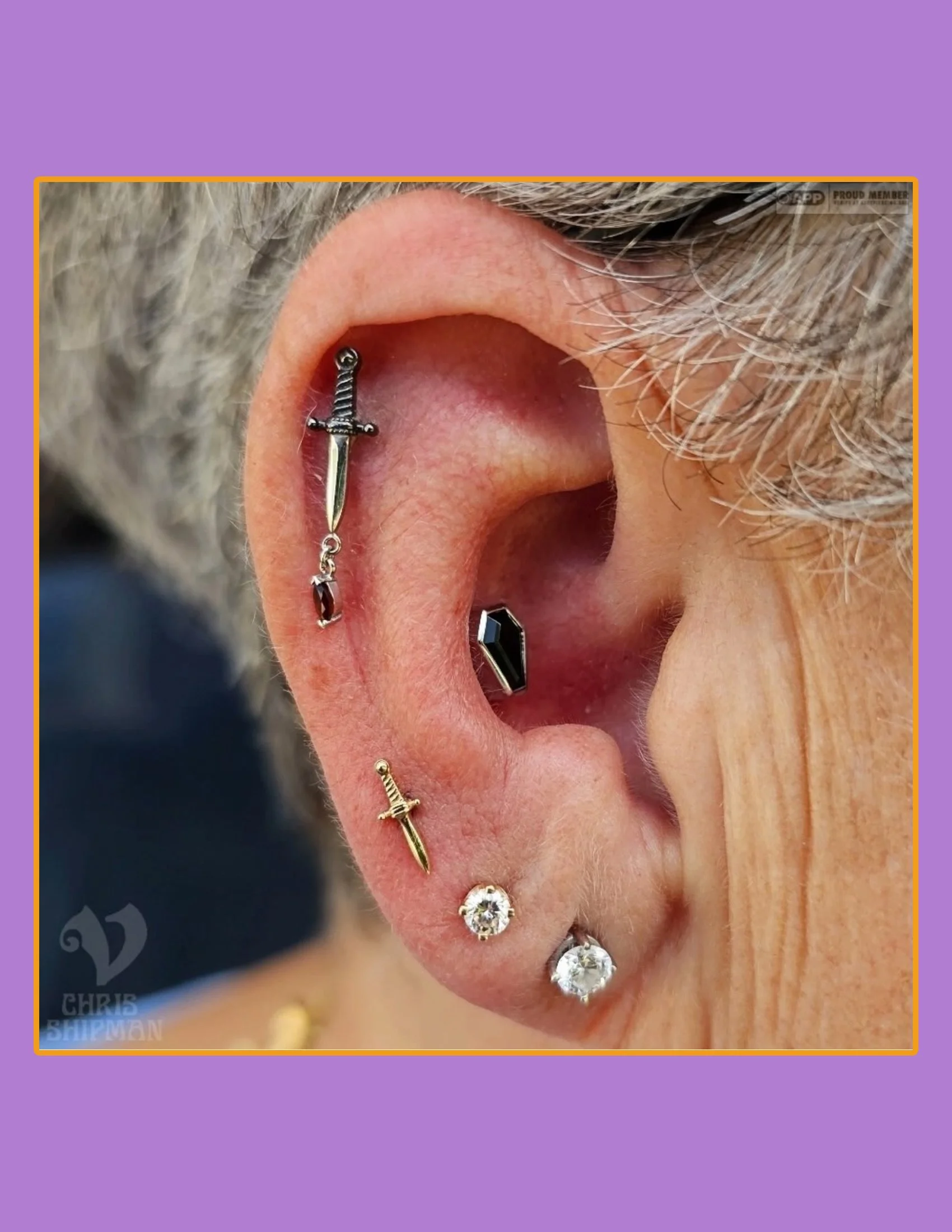 Lobe piercings by Chris Shipman at Visions Tattoo Gallery in Medway MA featuring slasher dagger and black Onyx coffin jewelry by BVLA