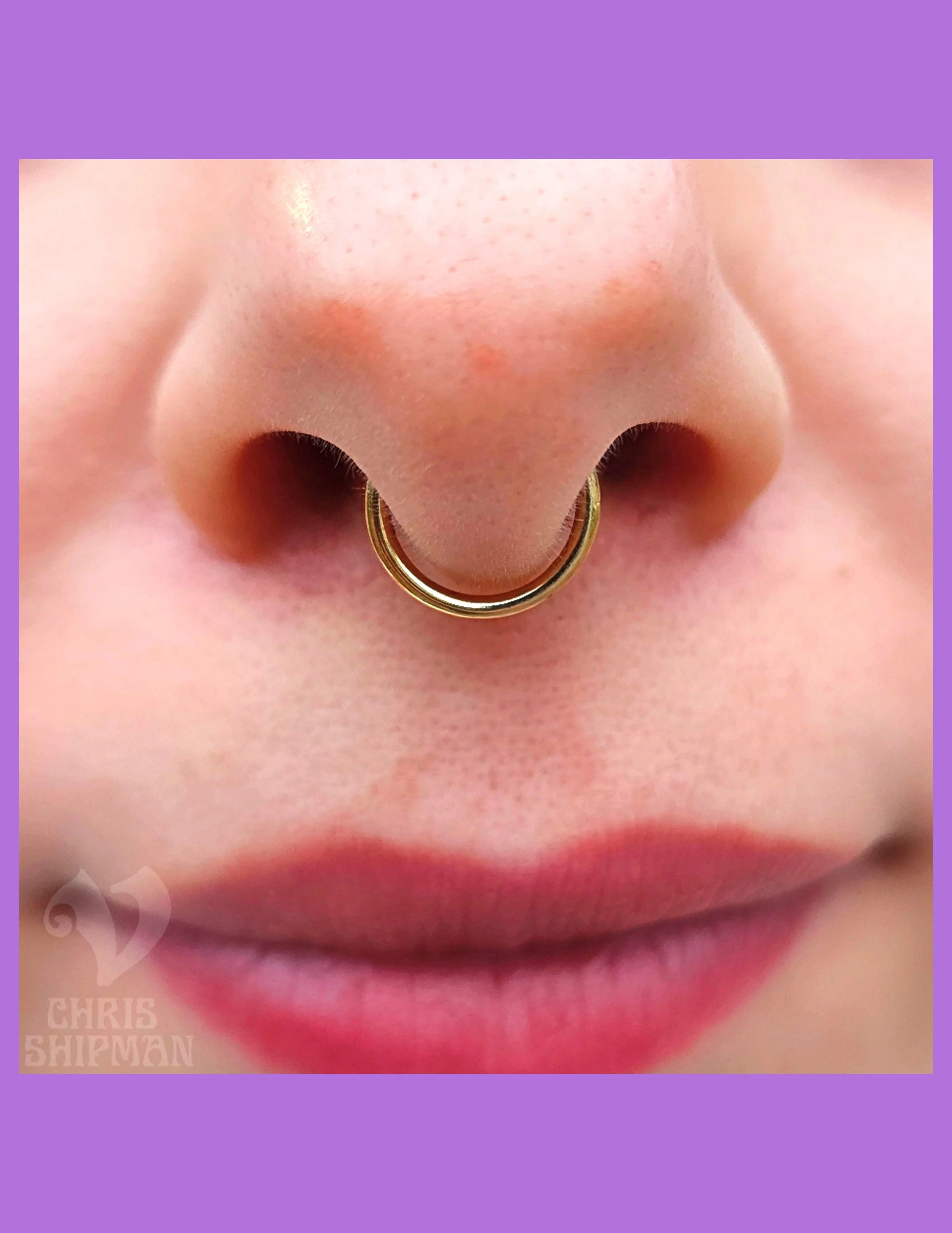Beautifully healed septum piercing by Chris Shipman at Visions Tattoo Gallery featuring a classic 14K gold seam ring in Medway MA.