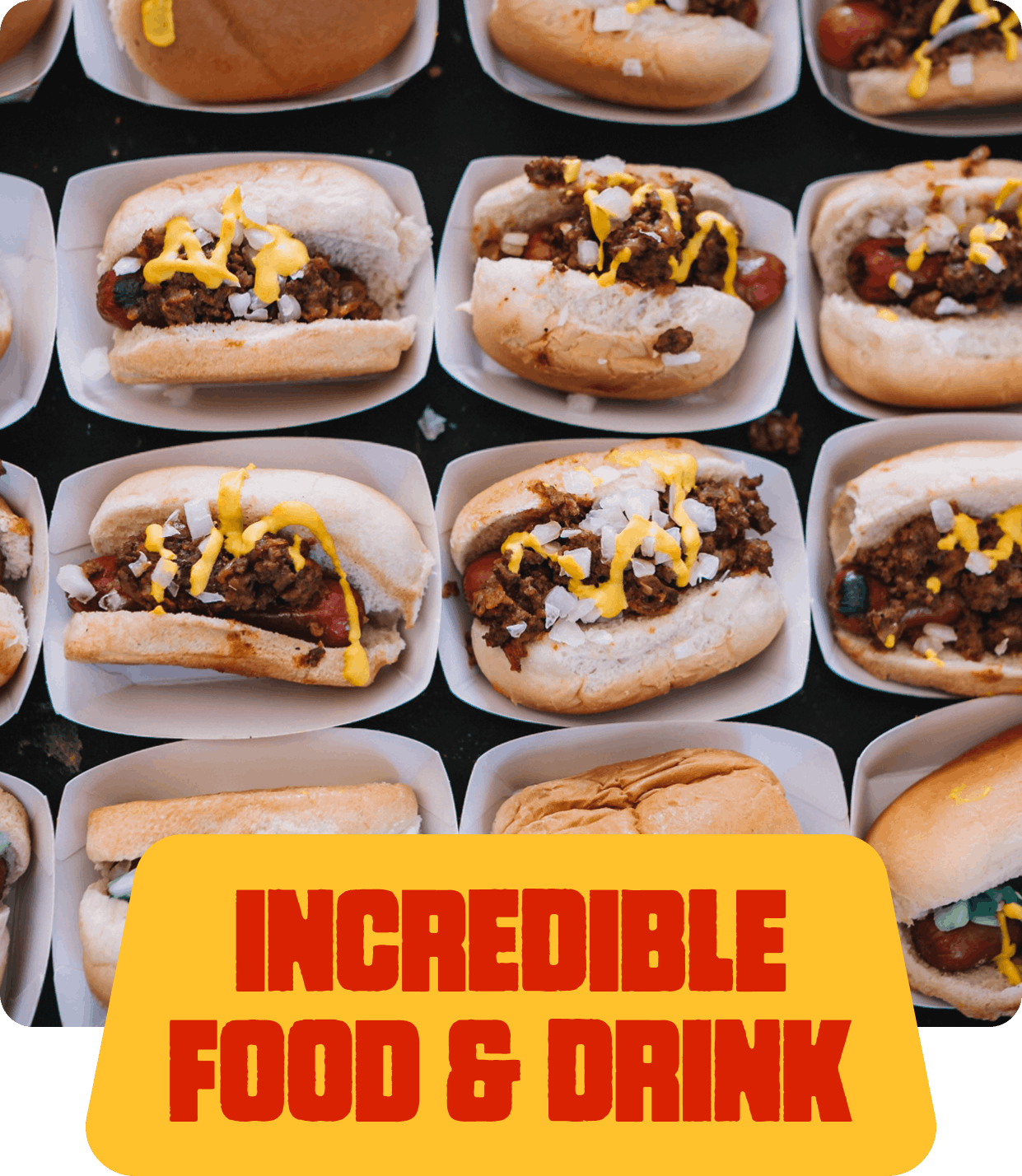 Close-up of hot dogs topped with mustard and chopped onions, arranged in individual paper trays.