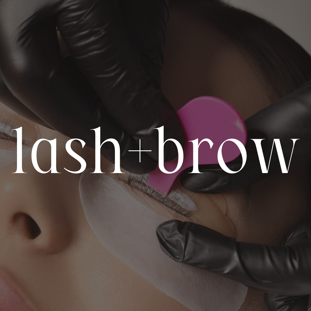 A close-up of a person receiving an eyelash and eyebrow extension treatment, with a technician wearing black gloves applying the extensions with a pink tool.