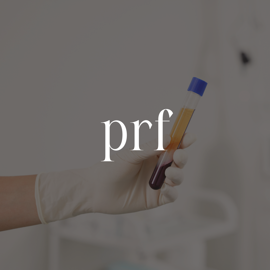 A gloved hand holding a test tube filled with blood in a laboratory setting.