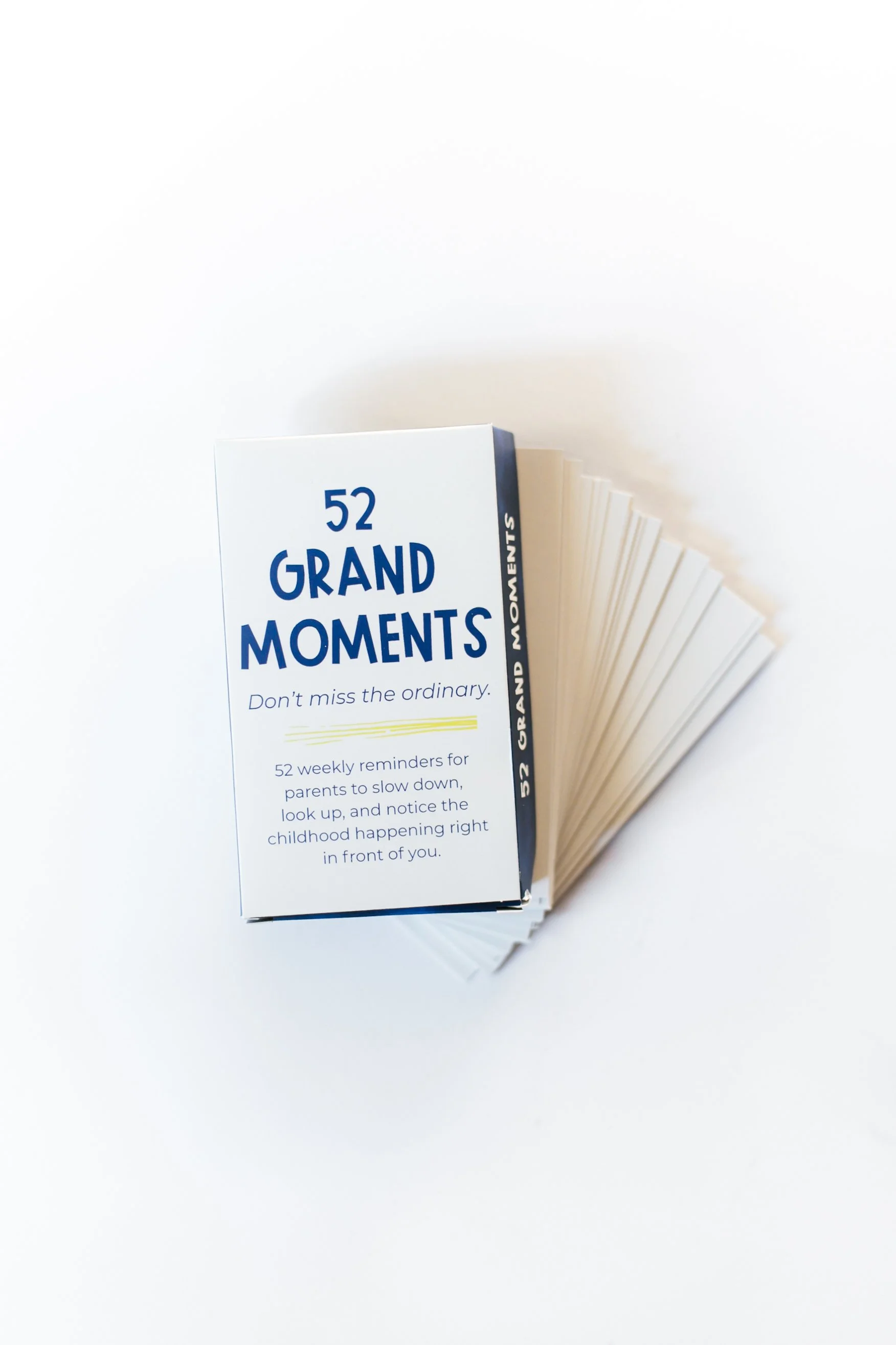 52 Grand Moments card deck with cards fanned behind the box, featuring simple reminders to connect with your kids.
