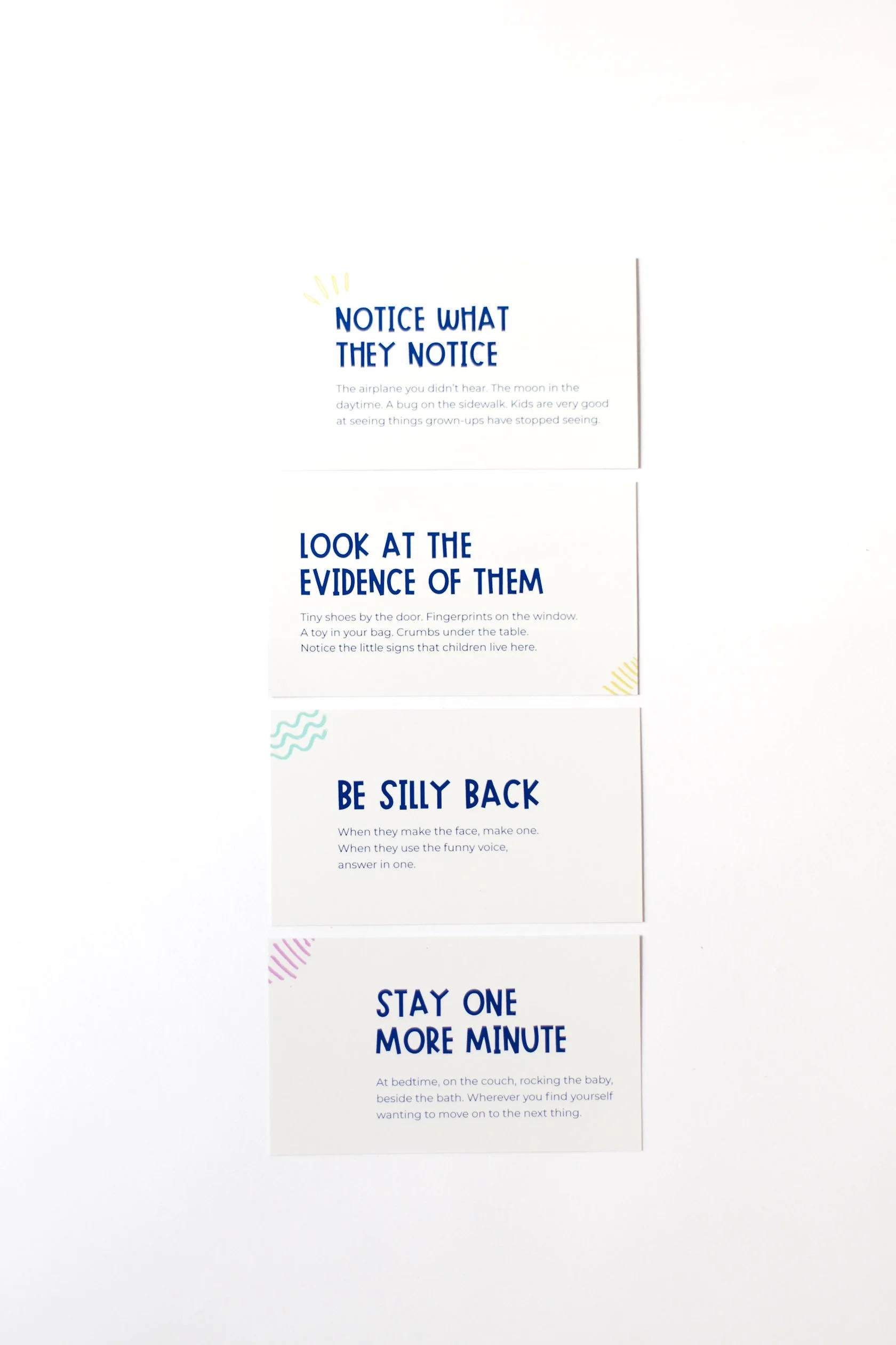 Four sample cards from the 52 Grand Moments deck with reminders to notice, play, remember, and connect during everyday family life.