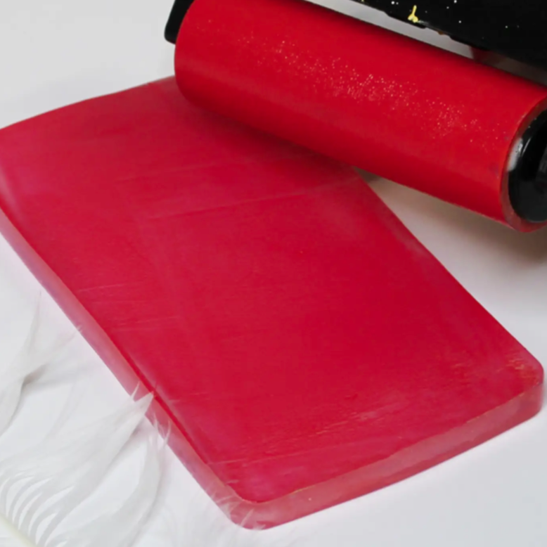 Gel plate with brayer, red paint