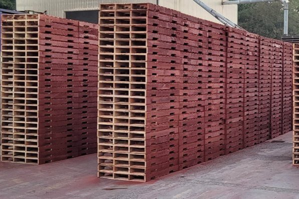 stacks of wood pallets painted red