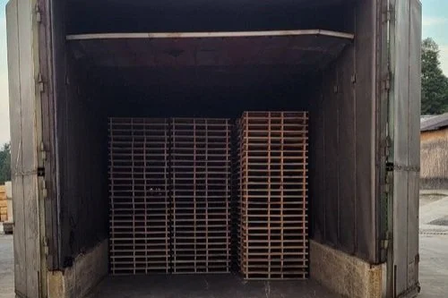stacks of wood pallets in heat treater machine