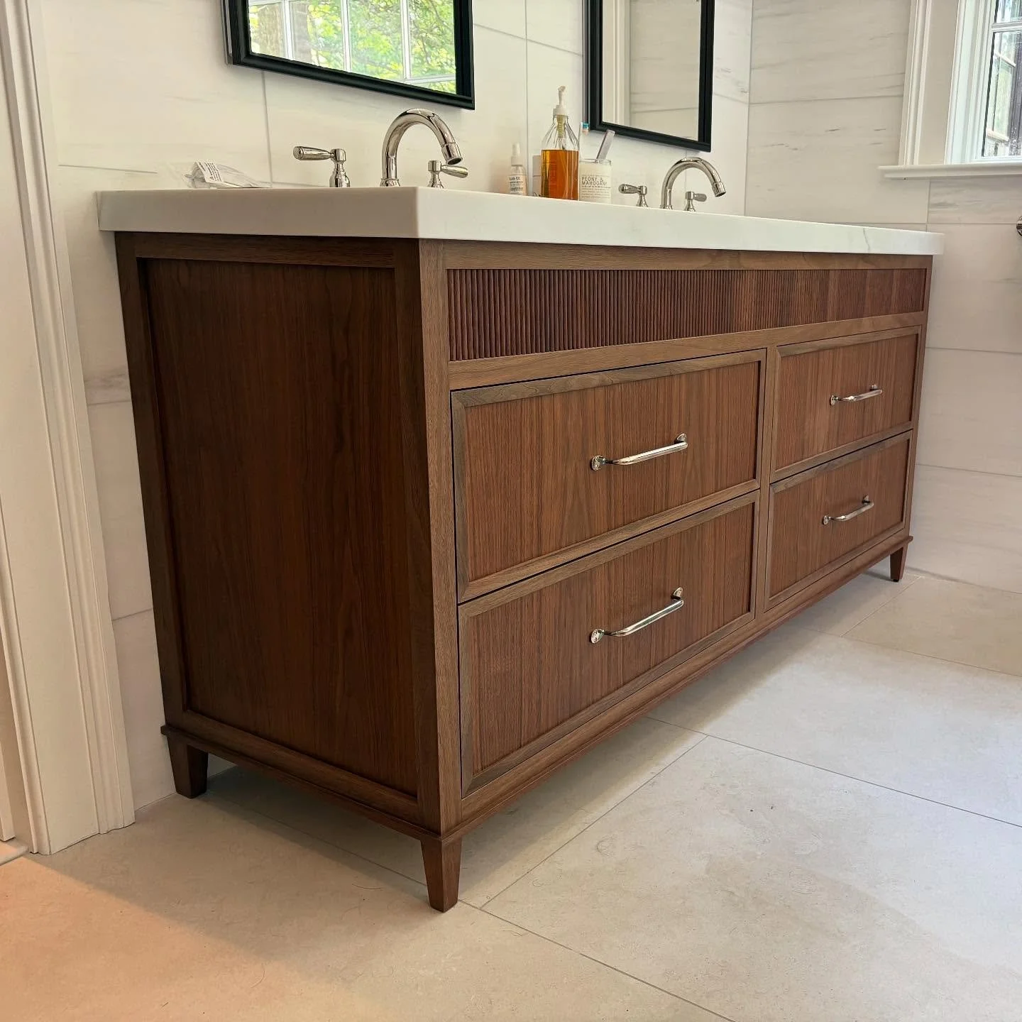 We are proud to share one of our recent favorites - this bespoke walnut vanity is a true standout. With just the right blend of modern and traditional elements, it brings warmth, elegance, and a totally custom touch to the space. What can we create f