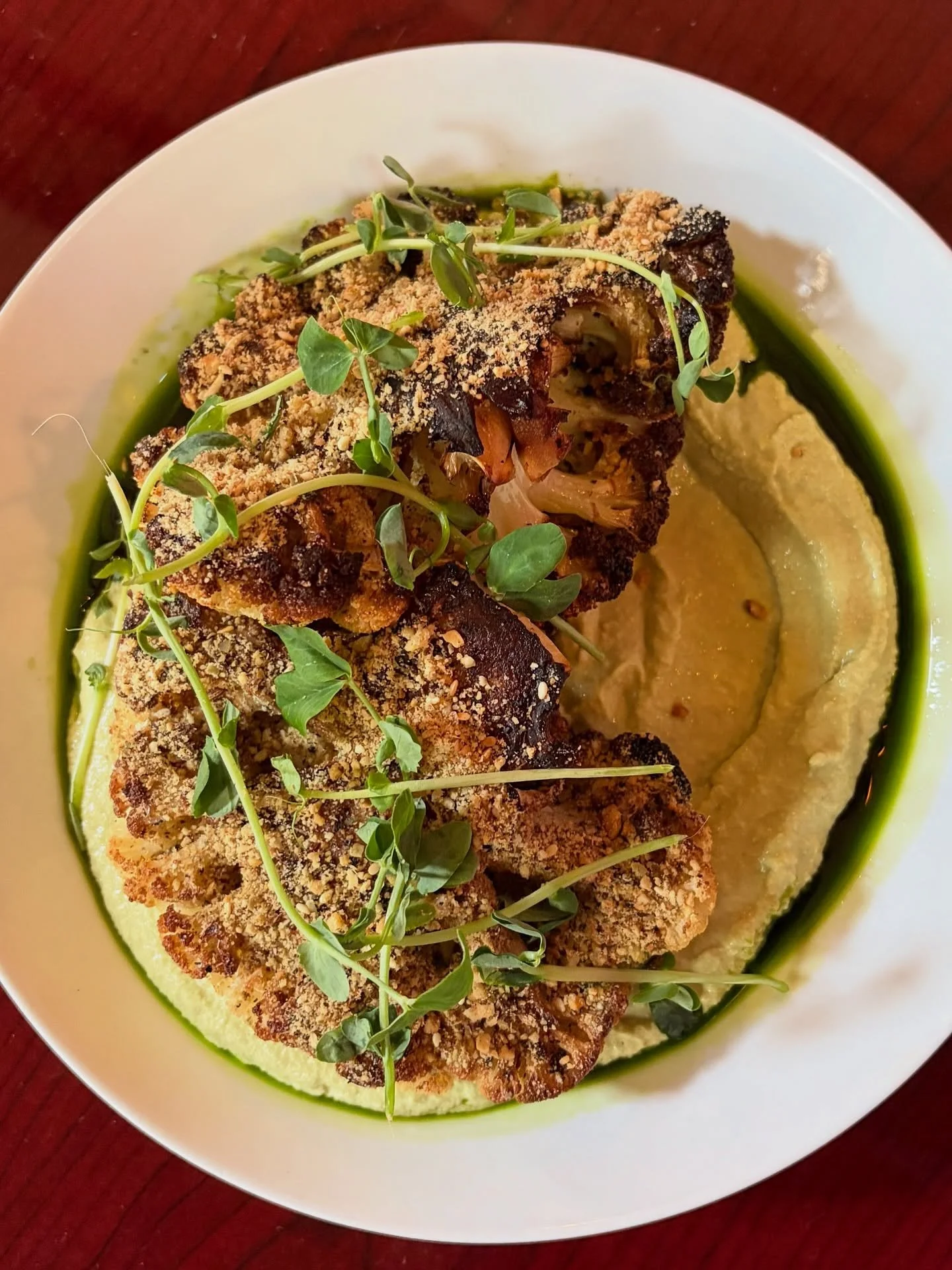 New for spring: 
Cauliflower Steak
Fava Bean Hummus, Mint Oil, Seeded Dukkah. Vegan.