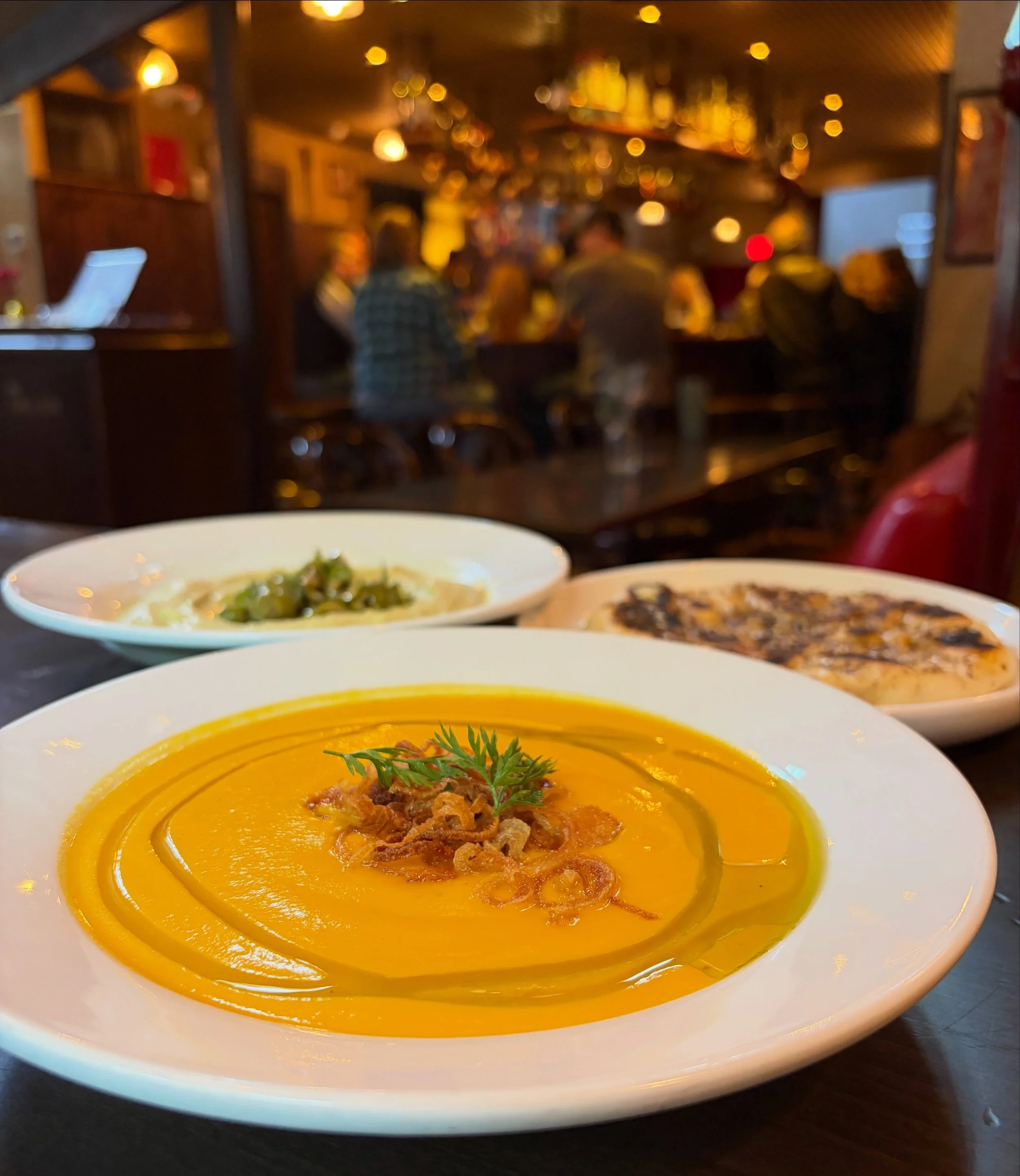 Some new spring flavors for the vegans and vegan-curious. 

Carrot Ginger Bisque with Crispy Shallots 

-> Fava Bean Hummus with house made sourdough naan (sub regular sourdough for naan to make it vegan!)