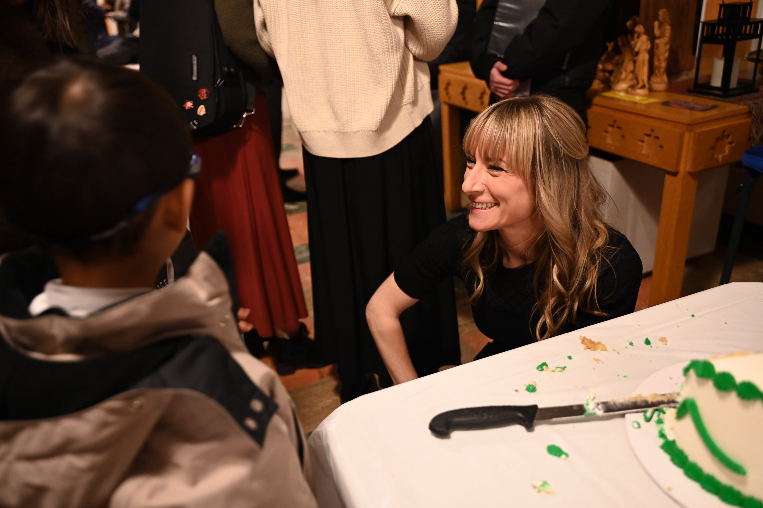 Carmen talks with one of her students after a recital with a smile
