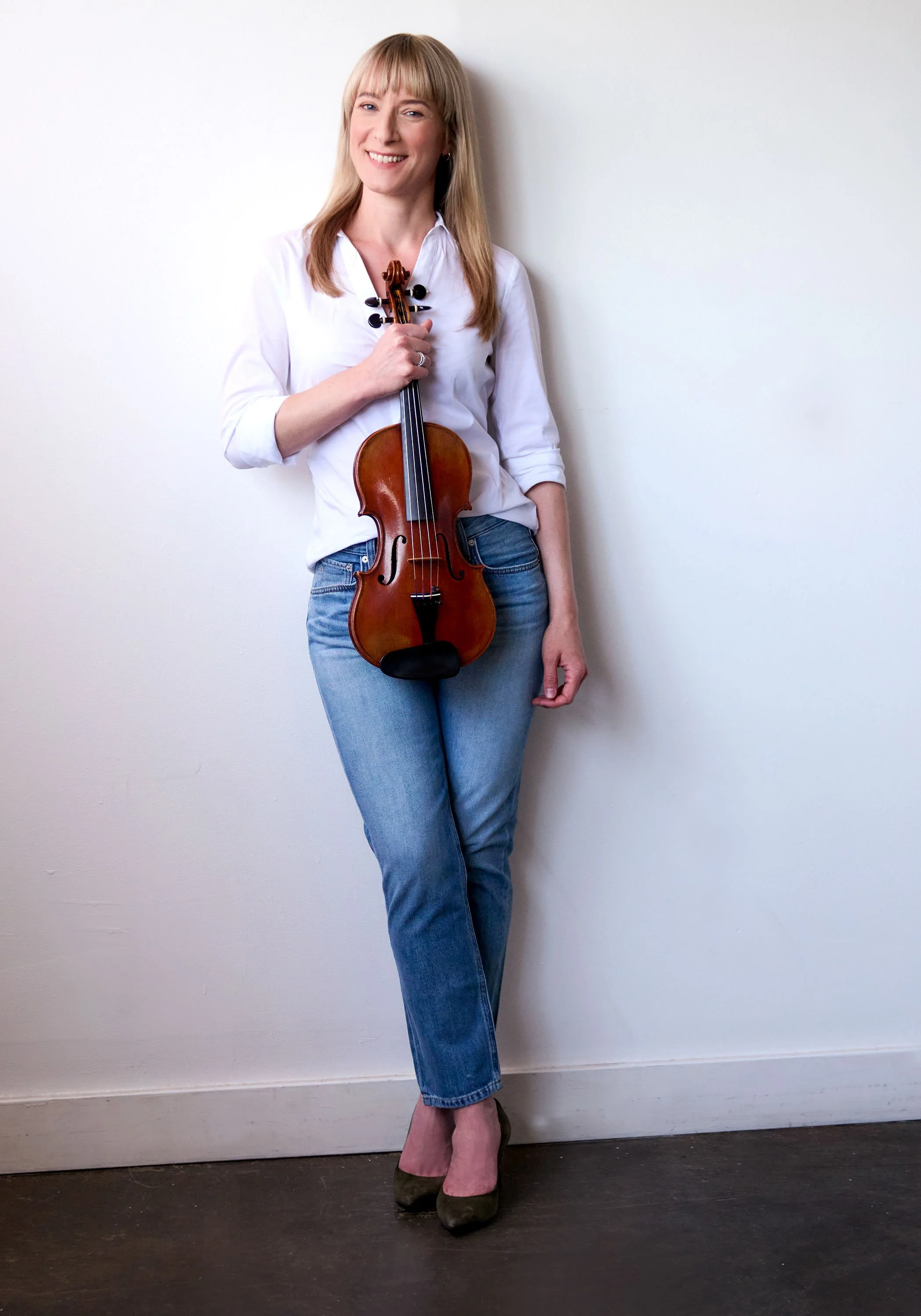 A photo of Carmen holding her violin.