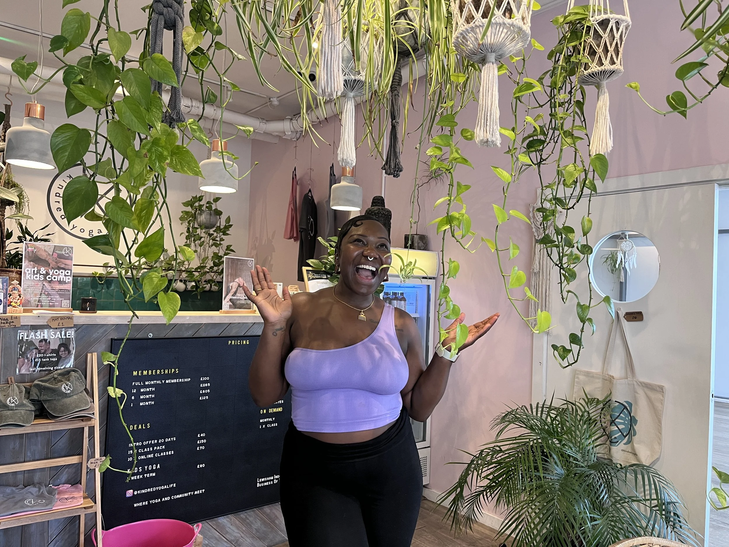 Women in a yoga space full of plants