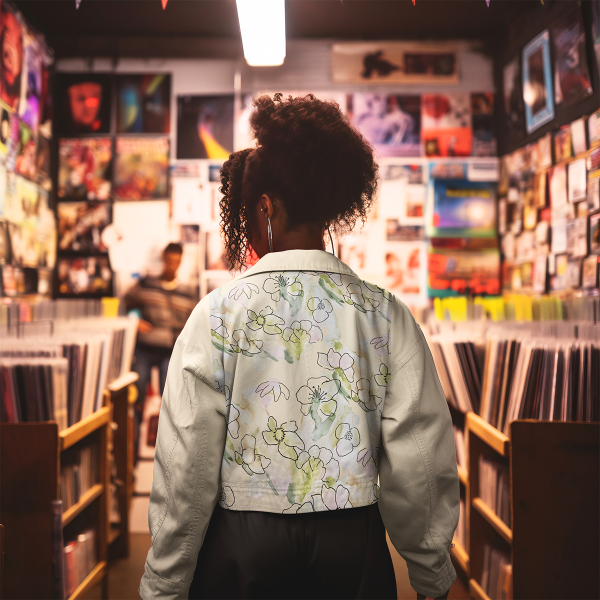 Black, female model wearing a cream jean jacket with floral print in soft pastels