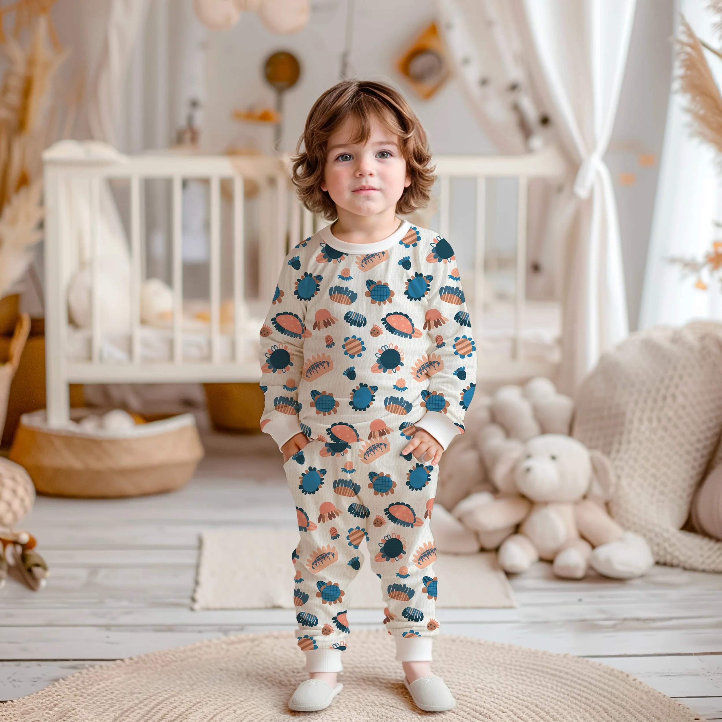 Caucasian, little boy wearing matching PJ set with a hand illustrated, multi-color, floral print.
