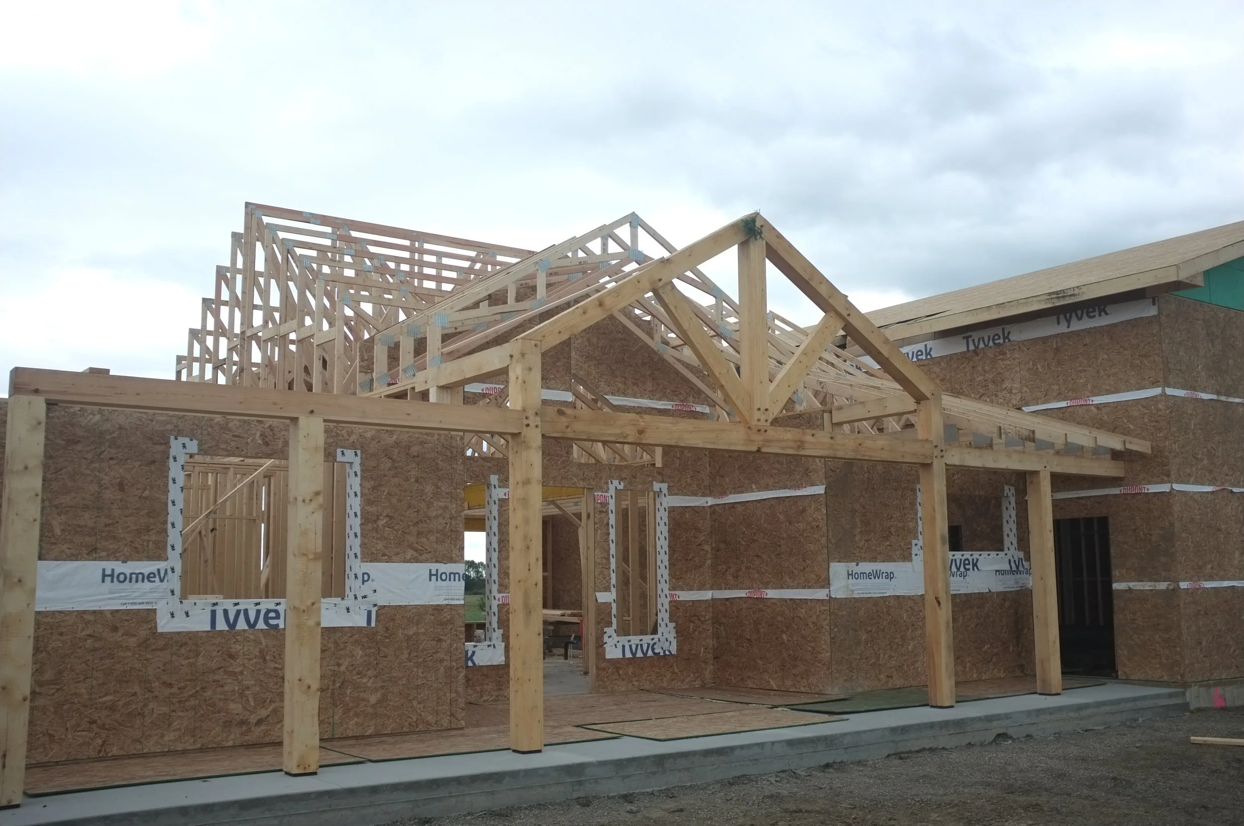 Timber-framed home entranceway and covered porch, 2025. (1/2)